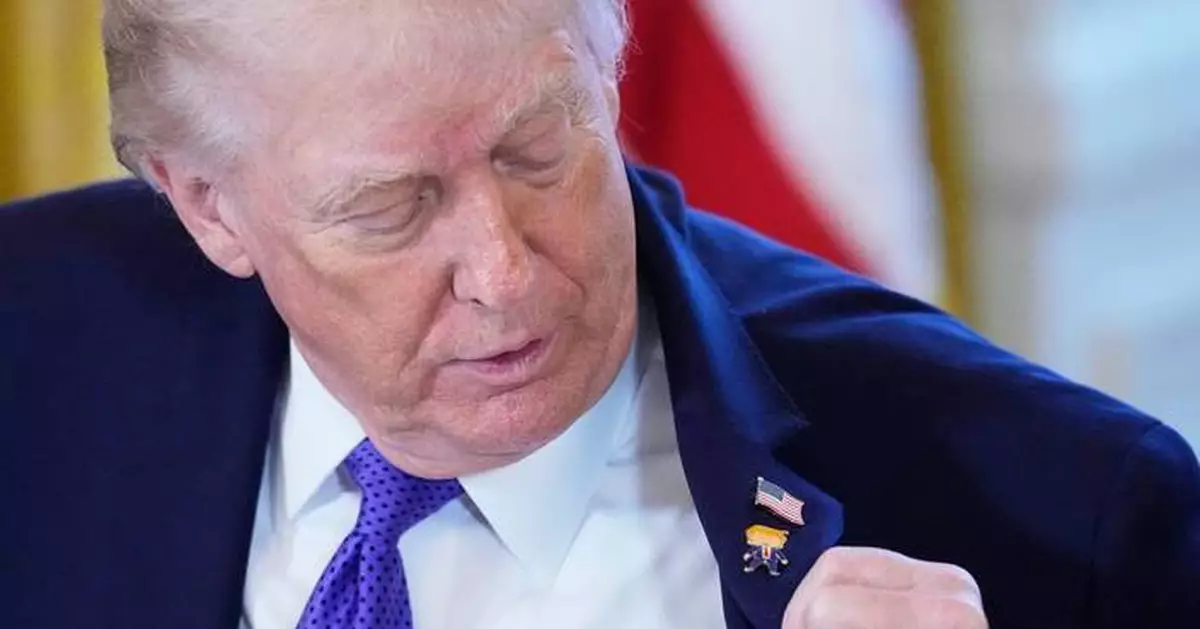 Trump wears a new 'Happy Trump' lapel pin, but insists he's never happy