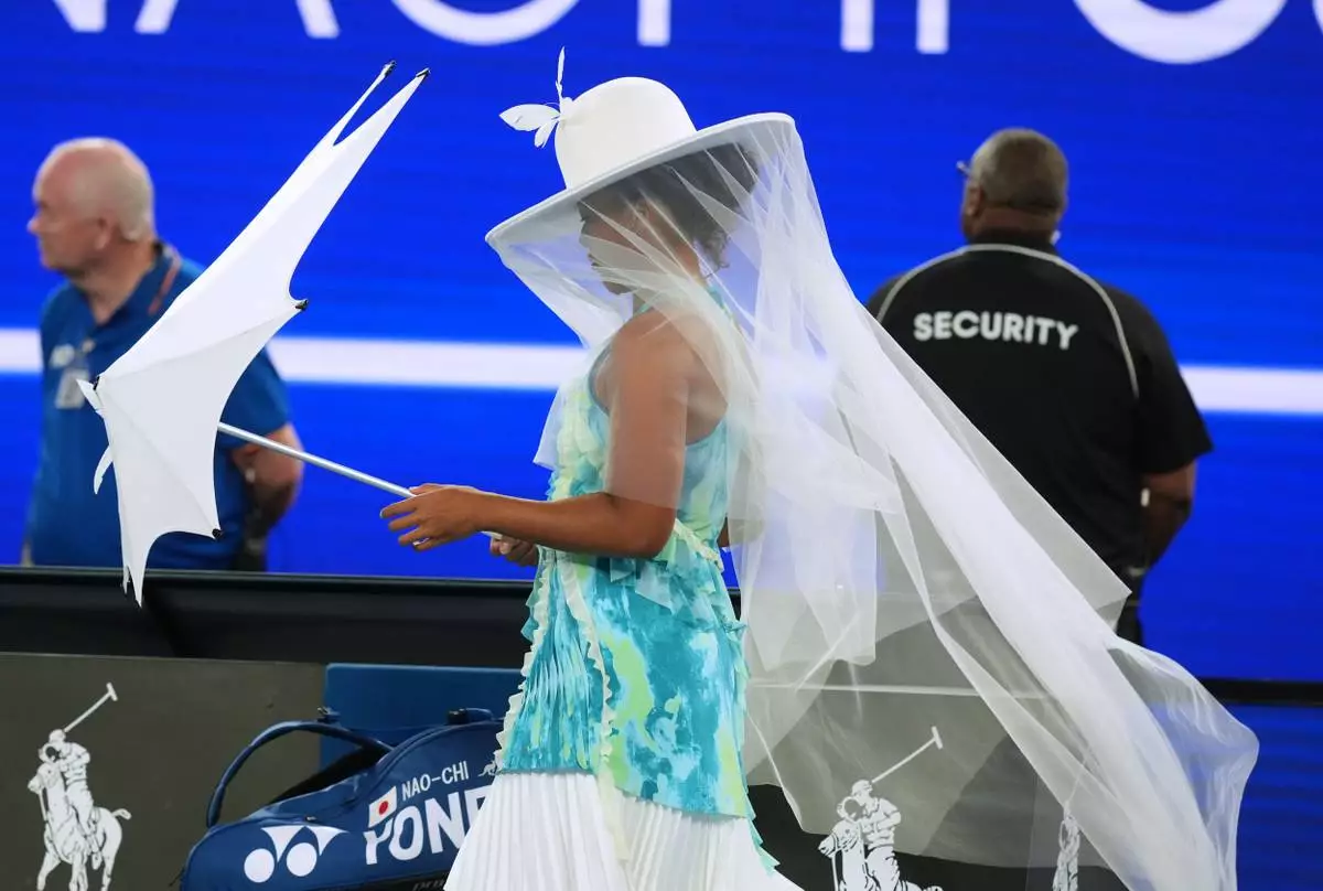 FILE - Naomi Osaka of Japan walks onto Rod Laver Arena for her first round match against Antonia Ruzic of Croatia at the Australian Open tennis championship in Melbourne, Australia, Tuesday, Jan. 20, 2026. (AP Photo/Asanka Brendon Ratnayake, File)