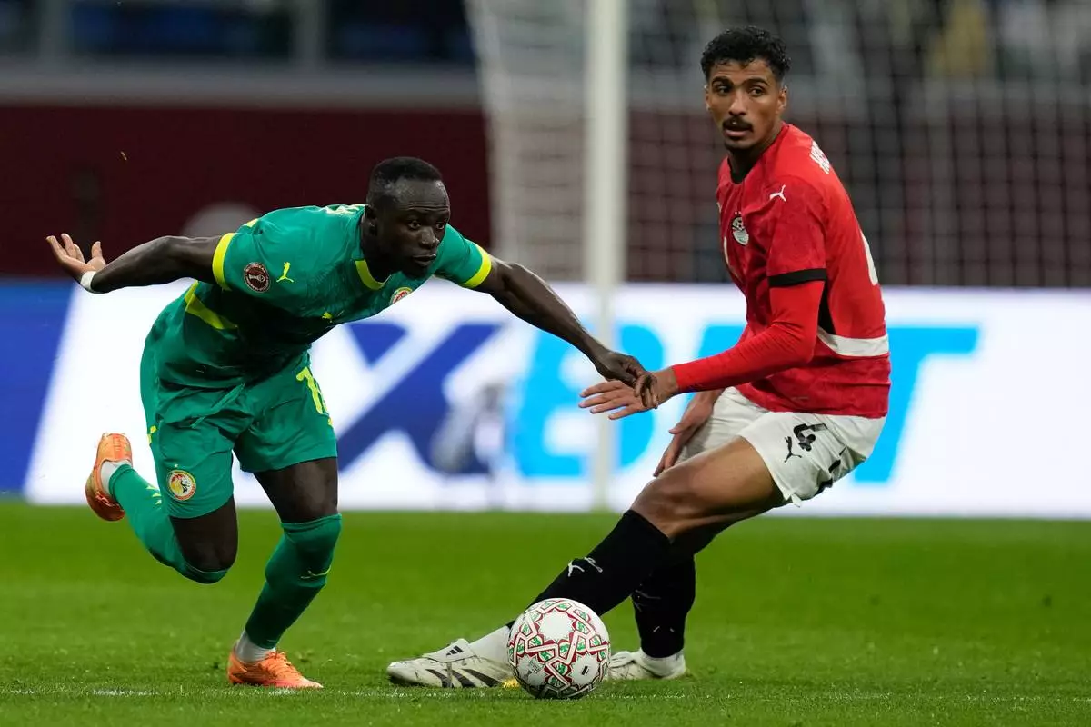Senegal's Sadio Mane, left, is challenged by Egypt's Hossam Abdelmaguid during the Africa Cup of Nations semifinal soccer match between Senegal and Egypt, in Tangier, Morocco, Wednesday, Jan. 14, 2026. (AP Photo/Themba Hadebe)