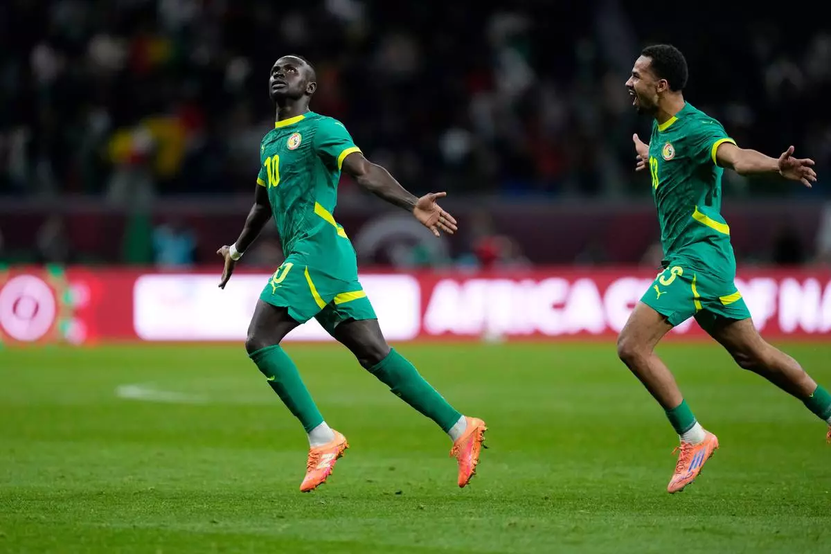 Senegal's Sadio Mane, left, celebrates after scoring his side's opening goal during the Africa Cup of Nations semifinal soccer match between Senegal and Egypt, in Tangier, Morocco, Wednesday, Jan. 14, 2026. (AP Photo/Themba Hadebe)