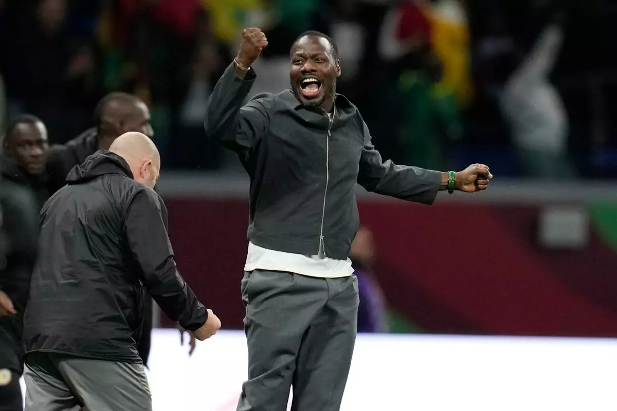 Senegal's head coach Pape Thiaw celebrates at the end of the Africa Cup of Nations semifinal soccer match between Senegal and Egypt, in Tangier, Morocco, Wednesday, Jan. 14, 2026. (AP Photo/Themba Hadebe)