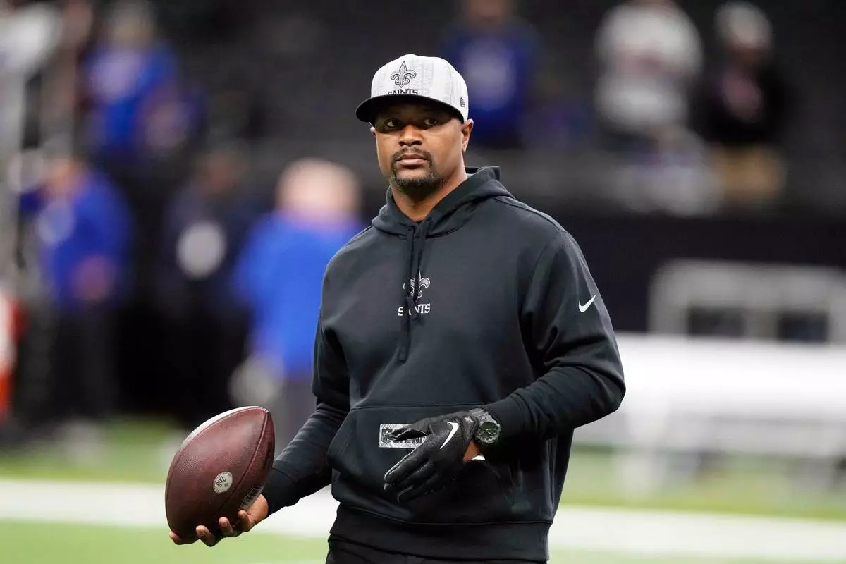 FILE - New Orleans Saints passing game coordinator/quarterbacks coach Ronald Curry walks on the field before an NFL football game against the New York Giants in New Orleans, Dec. 17, 2023. (AP Photo/Gerald Herbert, File)