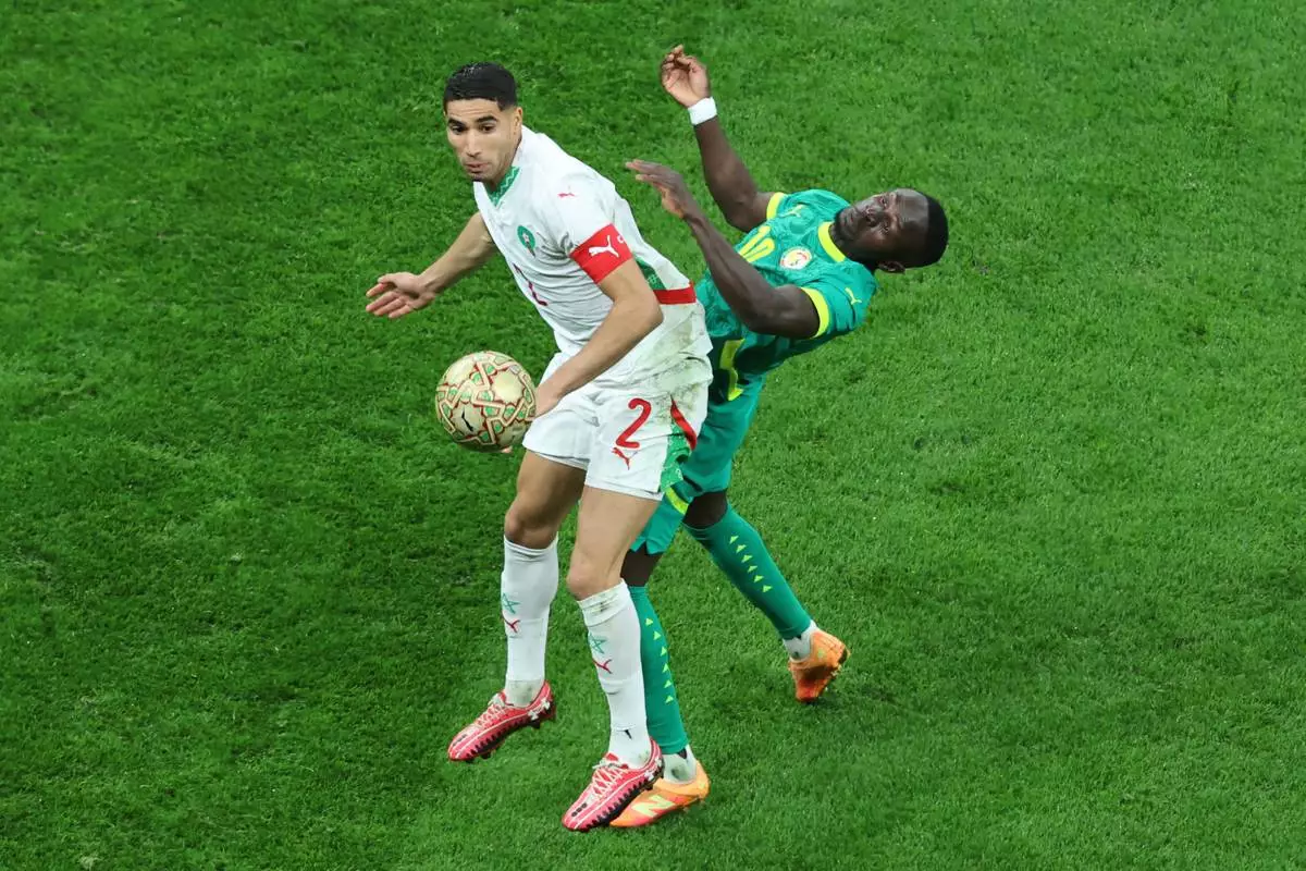 Morocco's Achraf Hakimi, left, and Senegal's Sadio Mane battle for the ball during the Africa Cup of Nations final soccer match between Senegal and Morocco in Rabat, Morocco, Sunday, Jan. 18, 2026. (AP Photo/Youssef Loulidi)