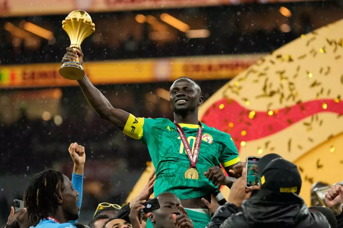Senegal's Sadio Mane holds the trophy aloft after winning the Africa Cup of Nations final soccer match agaisnt Morocco, in Rabat, Morocco, Sunday, Jan. 18, 2026. (AP Photo/Mosa'ab Elshamy)