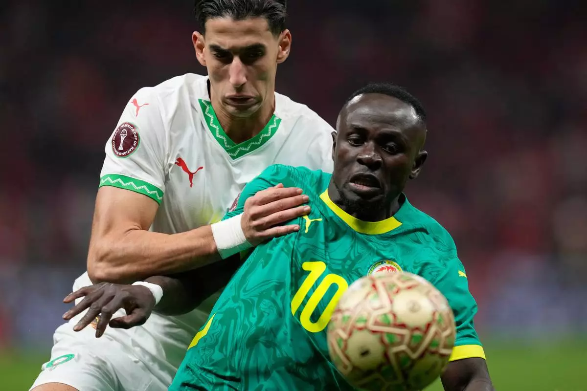 Senegal's Sadio Mane, front, and Morocco's Nayef Aguerd challenge for the ball during the Africa Cup of Nations final soccer match between Senegal and Morocco, in Rabat, Morocco, Sunday, Jan. 18, 2026. (AP Photo/Themba Hadebe)