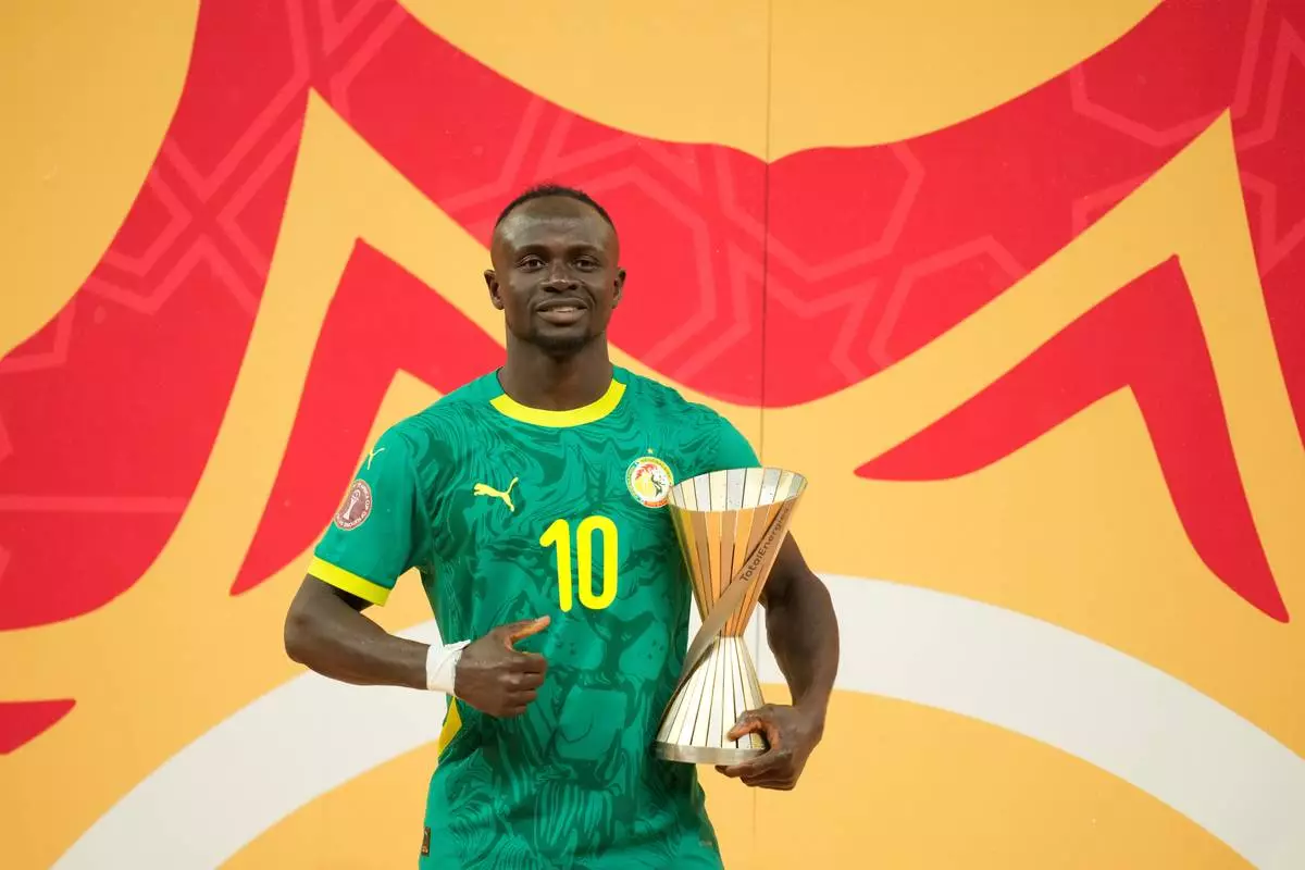 Senegal's Sadio Mane holds tropy for the best player of the torunament after the Africa Cup of Nations final soccer match between Senegal and Morocco, in Rabat, Morocco, Sunday, Jan. 18, 2026. (AP Photo/Mosa'ab Elshamy)