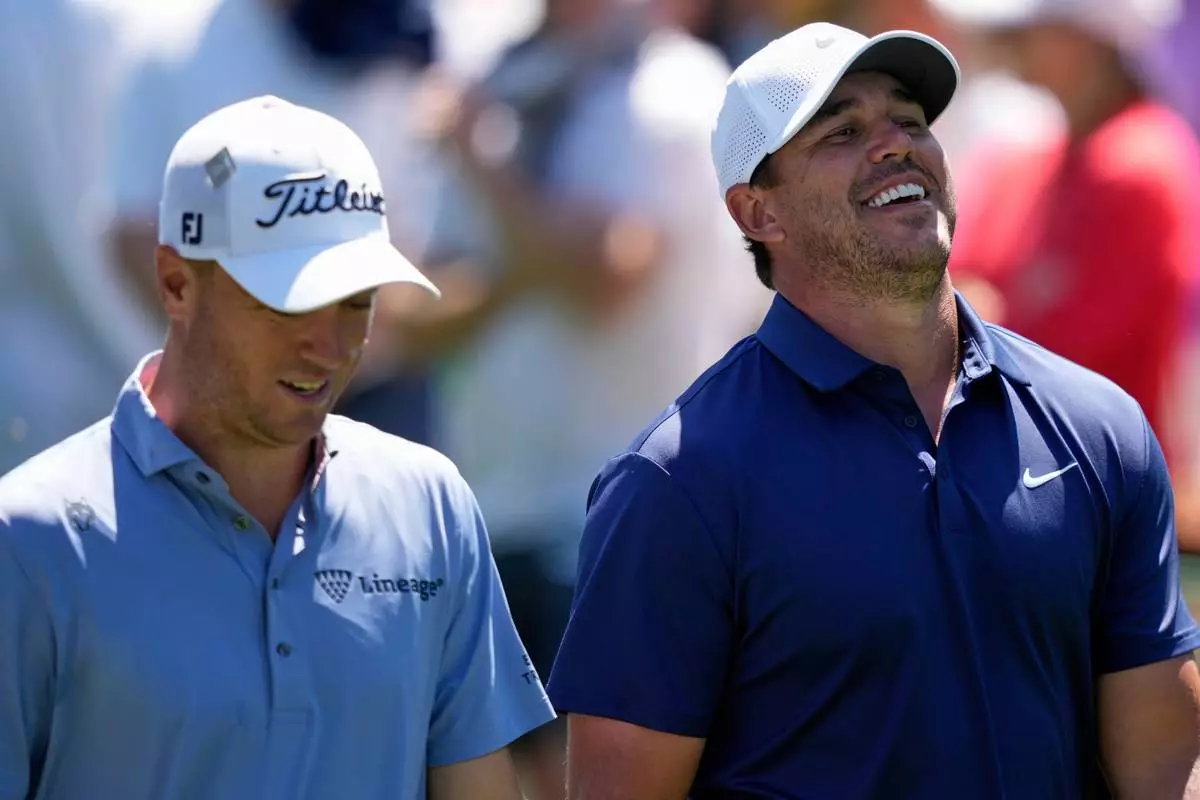 FILE - Brooks Koepka laughs while talking with Justin Thomas, left, on the 15th fairway during a practice round at the Masters golf tournament, Tuesday, April 8, 2025, in Augusta, Ga. (AP Photo/Matt Slocum, File)