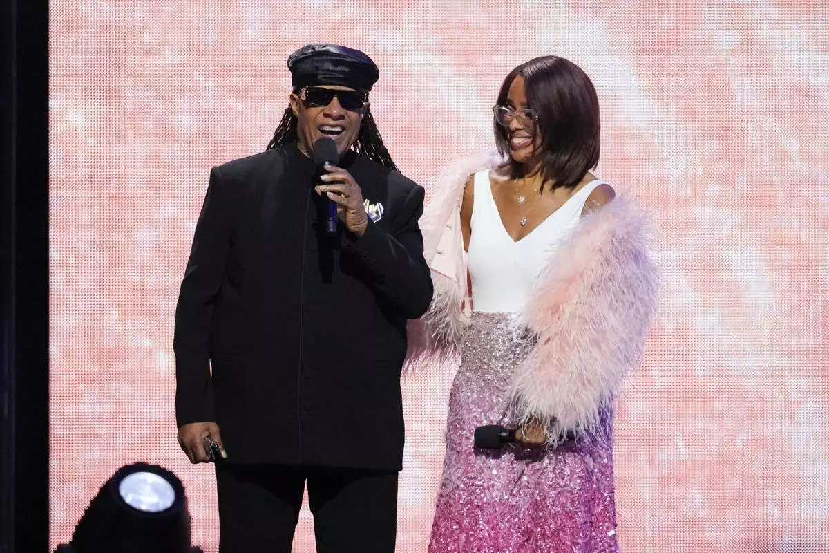 Stevie Wonder, left, and Gayle King speak during MusiCares Person of the Year honoring Mariah Carey on Friday, Jan. 30, 2026, in Los Angeles. (AP Photo/Chris Pizzello)