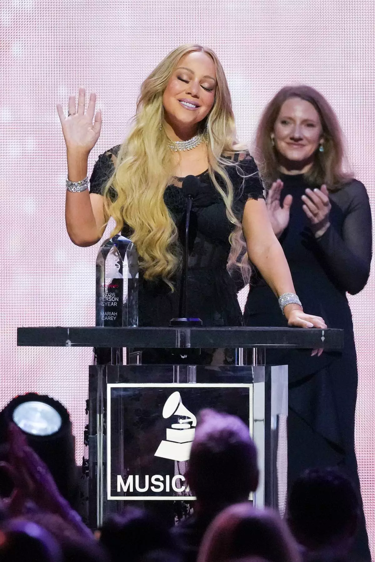 Mariah Carey, center, accepts the 2026 MusiCares Persons of the Year award during MusiCares Person of the Year honoring Mariah Carey on Friday, Jan. 30, 2026, in Los Angeles. (AP Photo/Chris Pizzello)