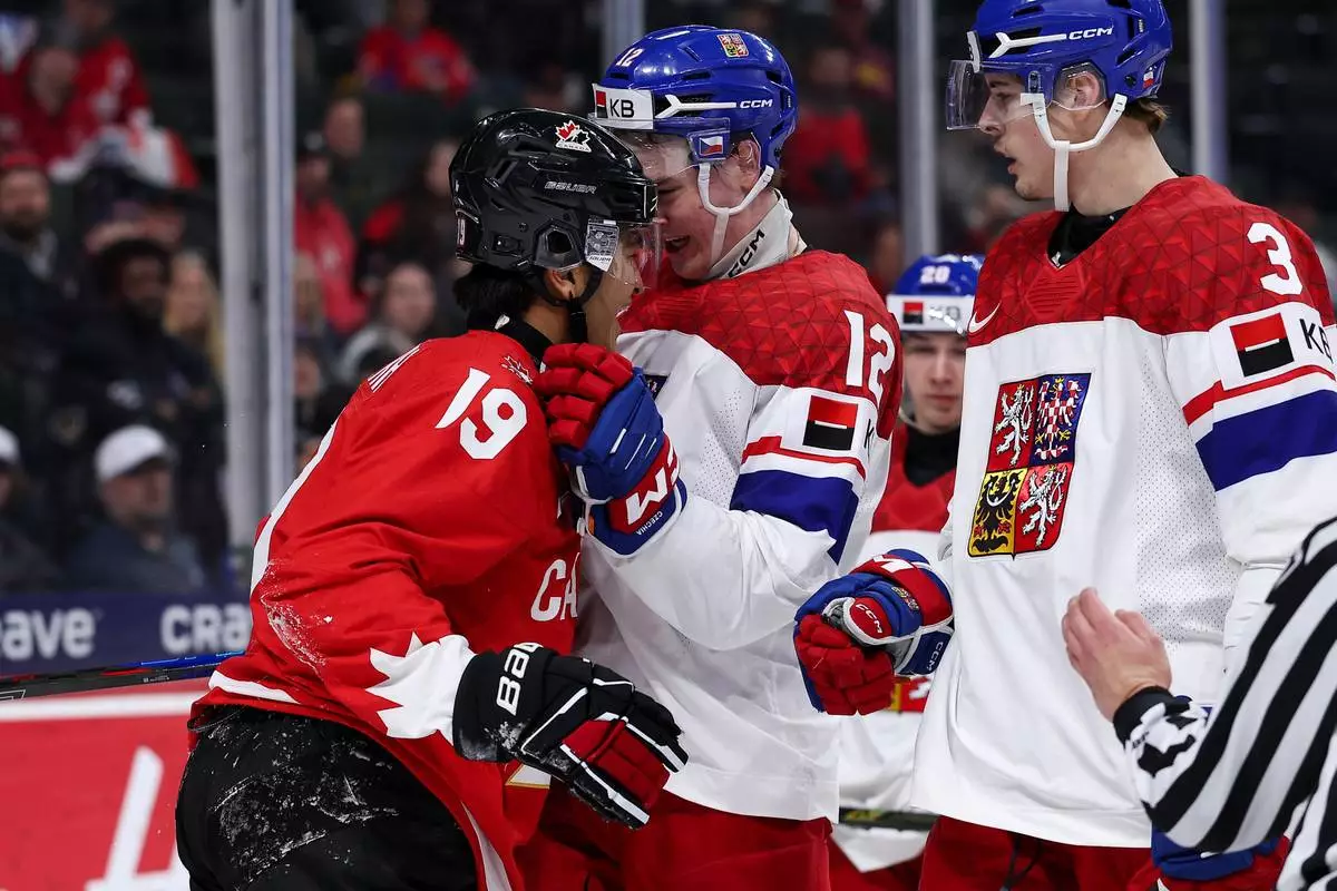Canada defense Zayne Parekh, left, and Czechia forward Maxmilian Curran (12) exchange words during the second period of an IIHF World Junior Hockey Championship semifinals game, Sunday, Jan. 4, 2026, in St. Paul, Minn. (AP Photo/Matt Krohn)