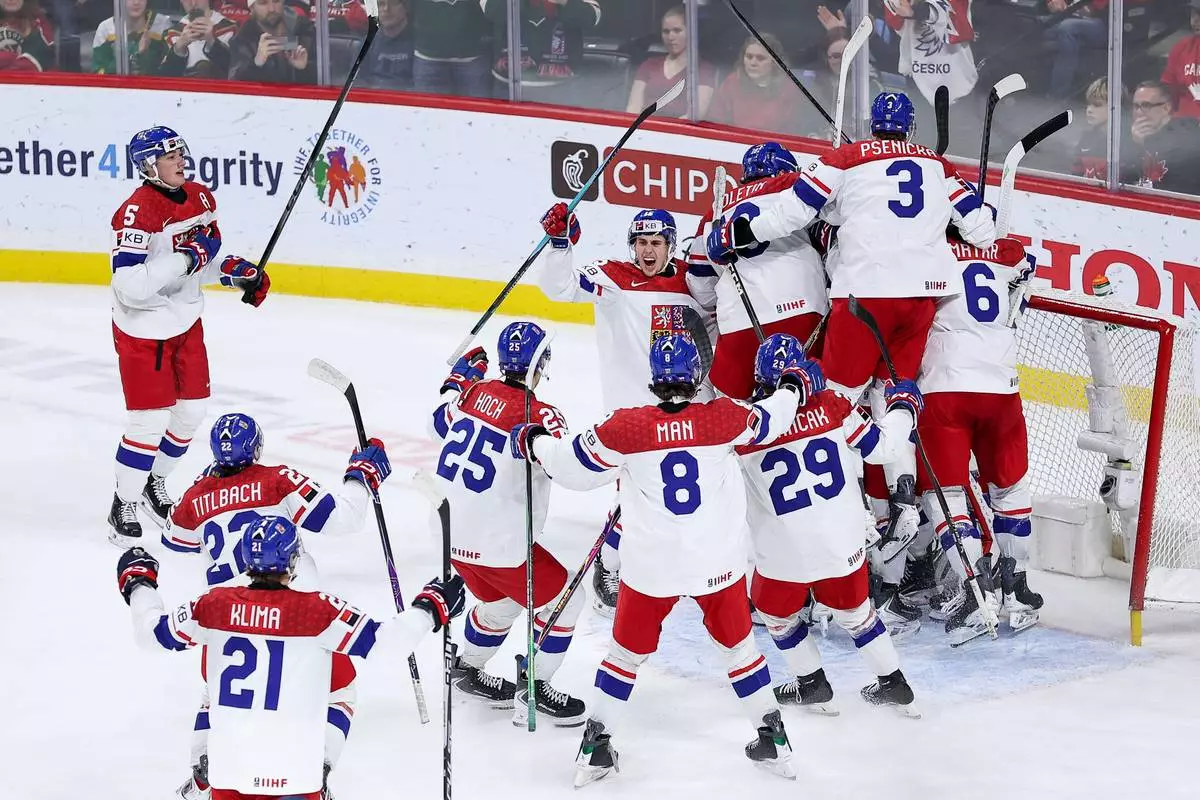 Czechia players celebrate their teams win during the third period of an IIHF World Junior Hockey Championship semifinals game against Canada, Sunday, Jan. 4, 2026, in St. Paul, Minn. (AP Photo/Matt Krohn)
