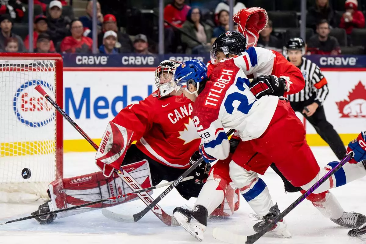 Czechia's Adam Titlbach (22) shoots on Canada goaltender Jack Ivankovic during the second period of an IIHF World Junior Hockey Championship semifinals game, Sunday, Jan. 4, 2026, in St. Paul, Minn. (Christopher Katsarov/The Canadian Press via AP)