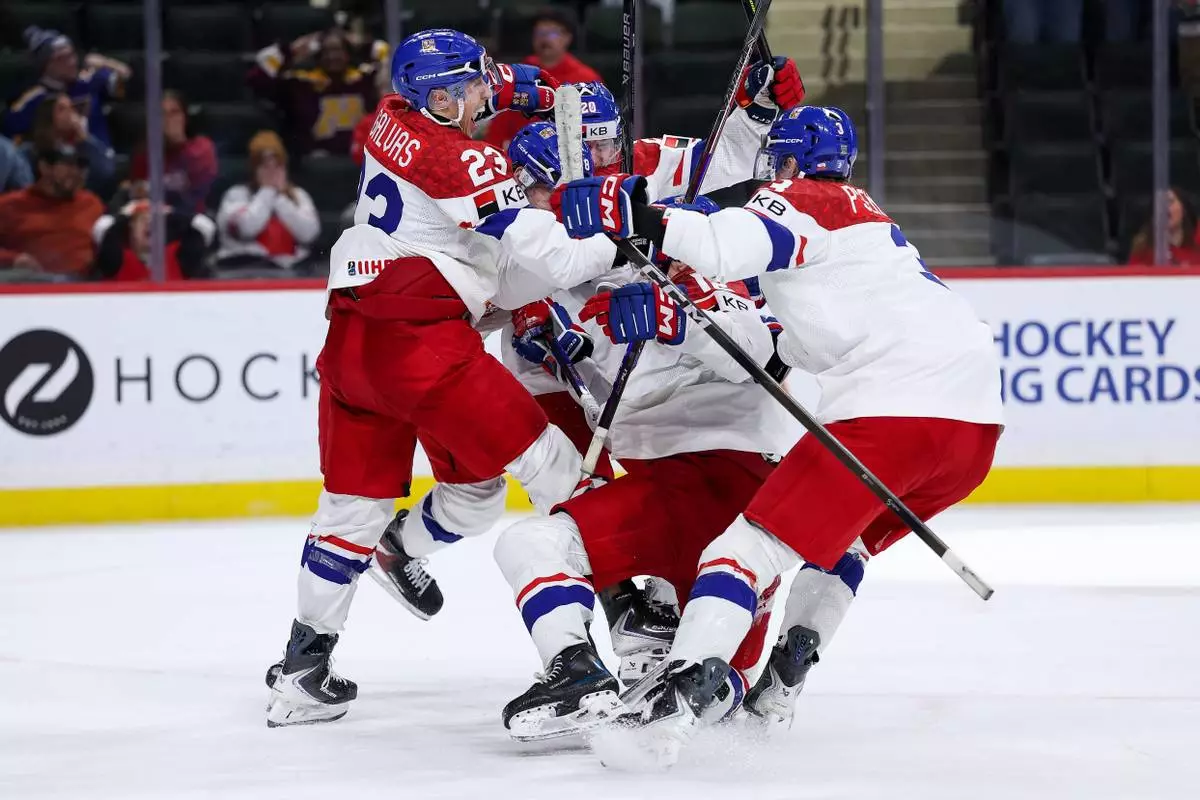 Czechia forward Tomas Poletin (18) celebrates his go ahead goal with teammates during the third period of an IIHF World Junior Hockey Championship semifinals game against Canada, Sunday, Jan. 4, 2026, in St. Paul, Minn. (AP Photo/Matt Krohn)