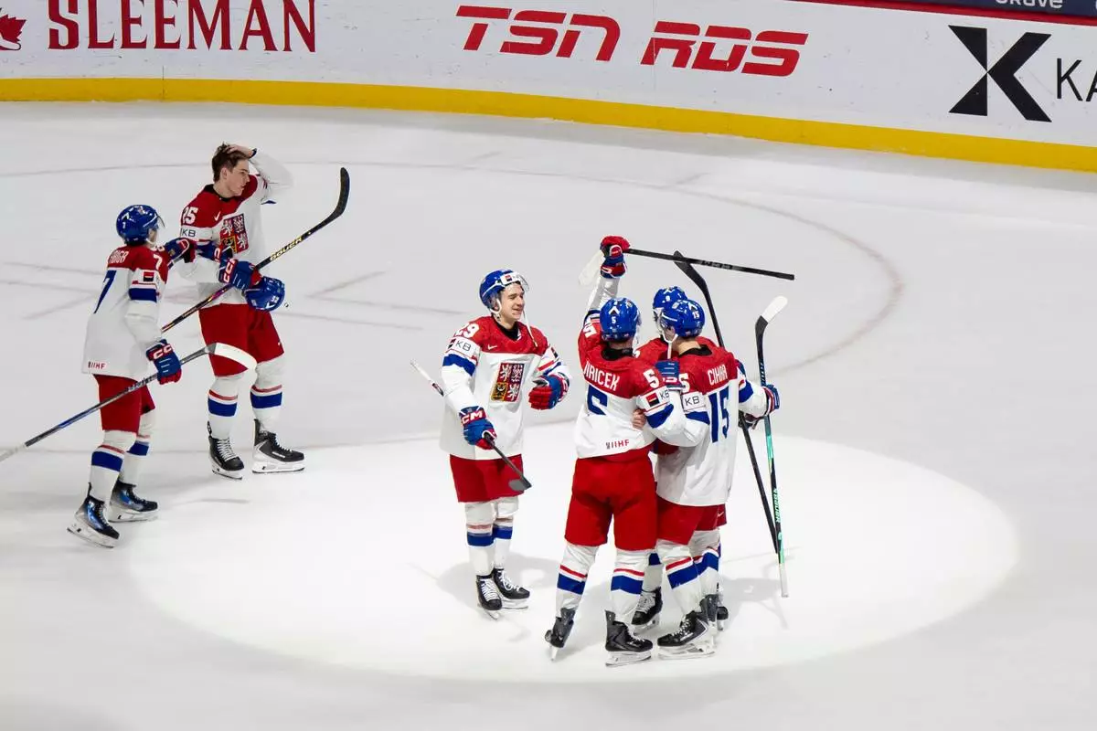 Team Czechia players celebrate after defeating Canada in an IIHF World Junior Hockey Championship semifinals game in St. Paul, Minn., Sunday, Jan. 4, 2026. (Christopher Katsarov/The Canadian Press via AP)