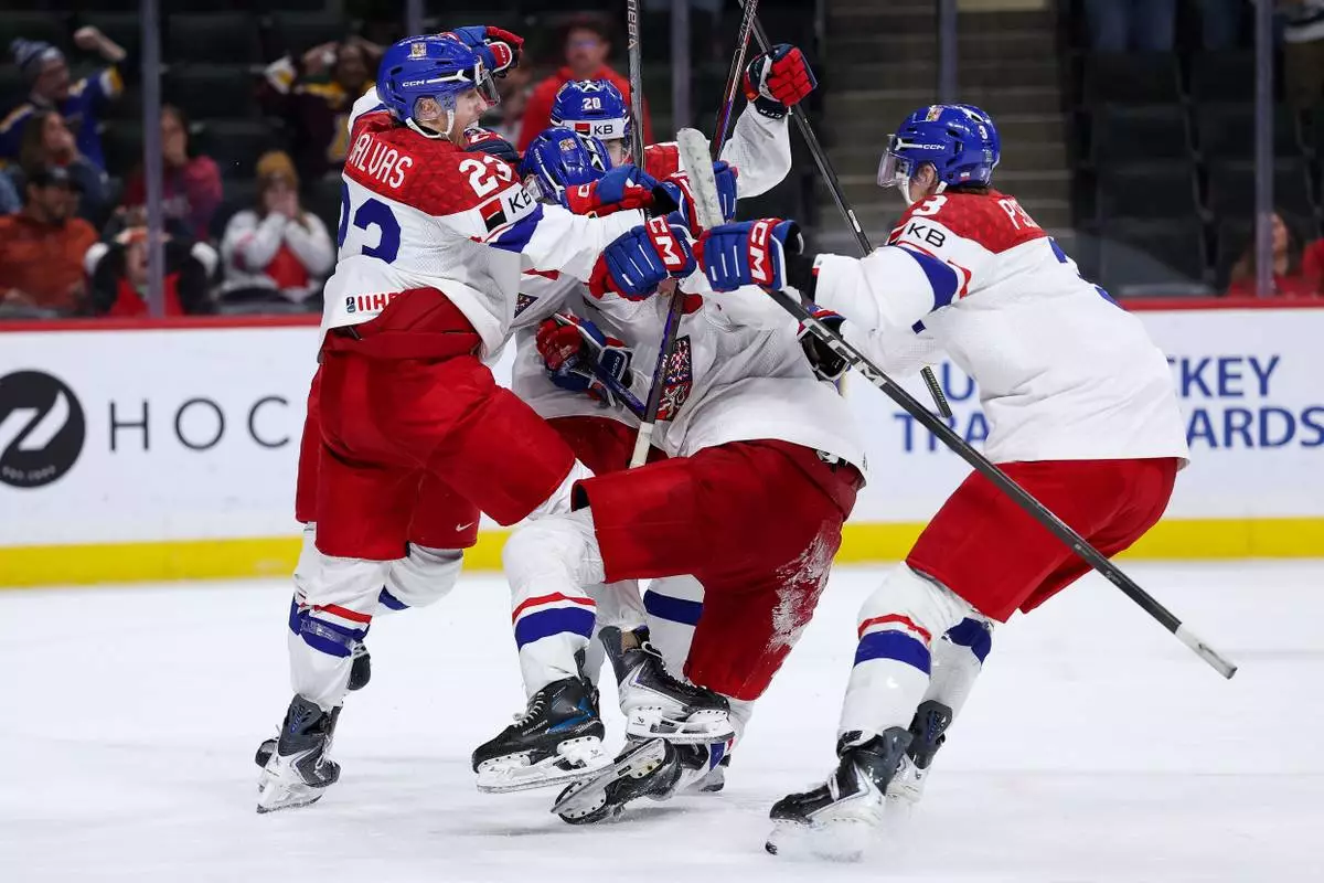 Czechia forward Tomas Poletin celebrates his go ahead goal with teammates during the third period of an IIHF World Junior Hockey Championship semifinals game against Canada, Sunday, Jan. 4, 2026, in St. Paul, Minn. (AP Photo/Matt Krohn)
