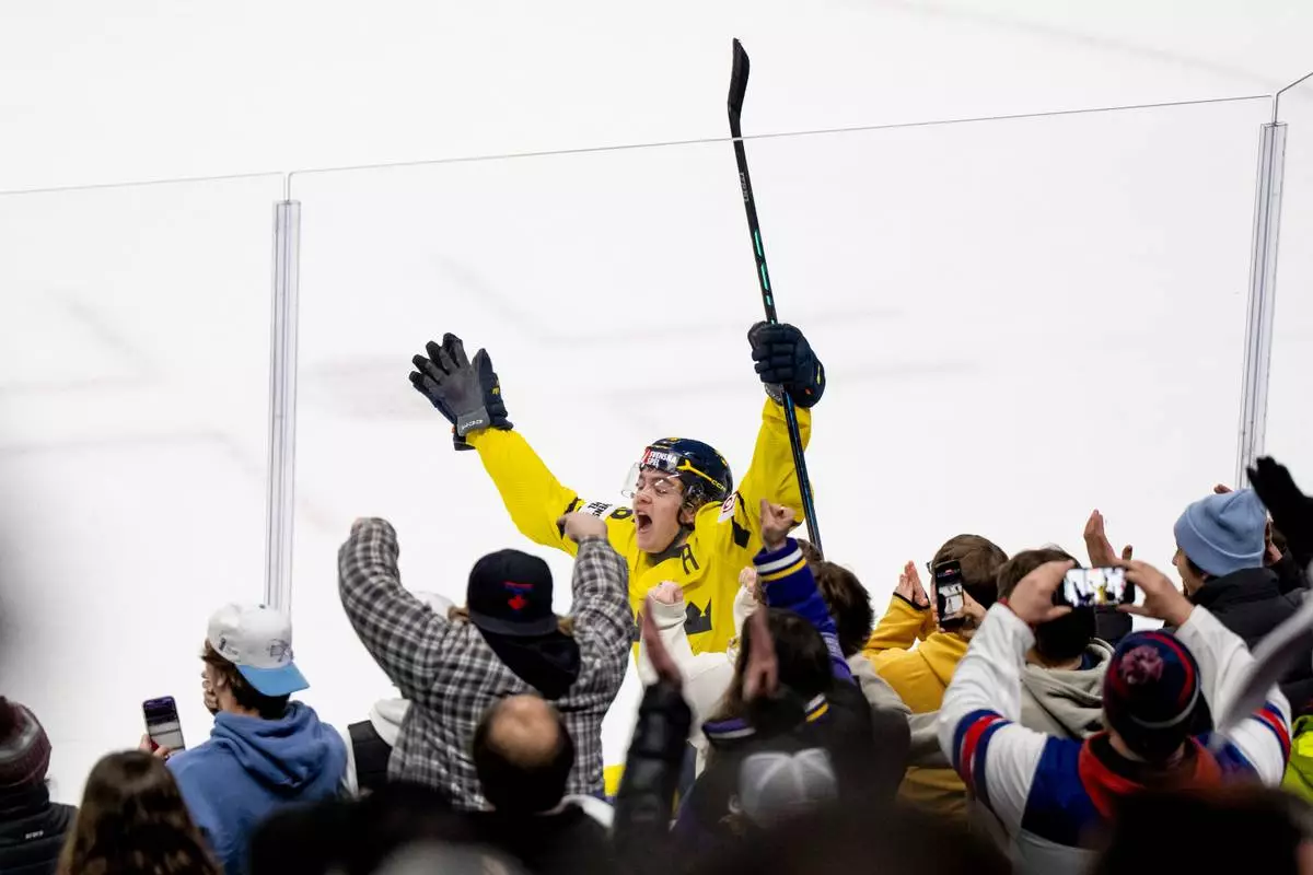 Sweden's Anton Frondell celebrates after scoring on Finland goaltender Petteri Rimpinen during overtime shoot-out in a semifinal IIHF World Junior Hockey Championship game in St. Paul, Minn., Sunday, Jan. 4, 2026. (Christopher Katsarov/The Canadian Press via AP)