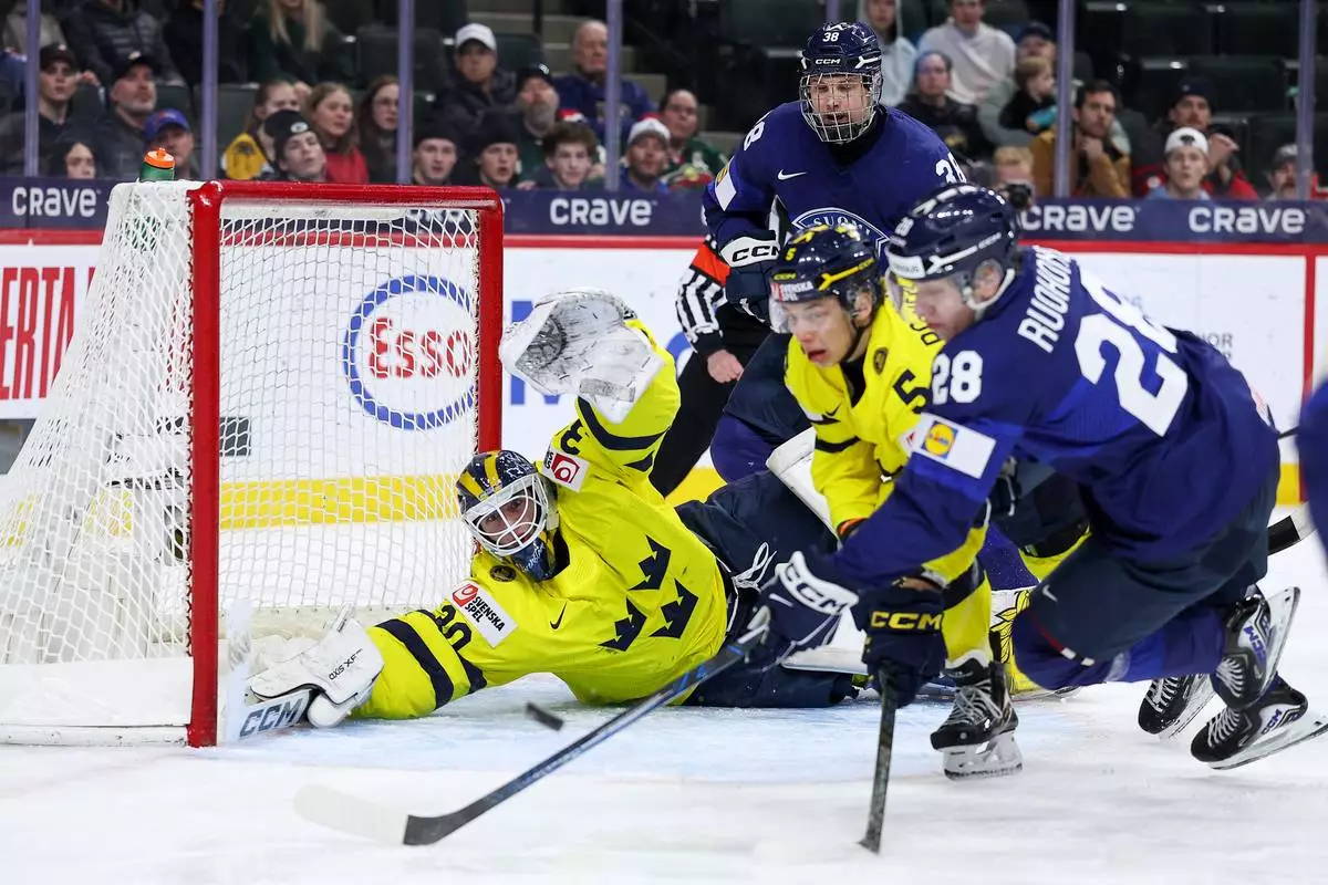 Sweden goalie Love Harenstam defends his net against Finland during the first period of an IIHF World Junior Hockey Championship semifinals game, Sunday, Jan. 4, 2026, in St. Paul, Minn. (AP Photo/Matt Krohn)