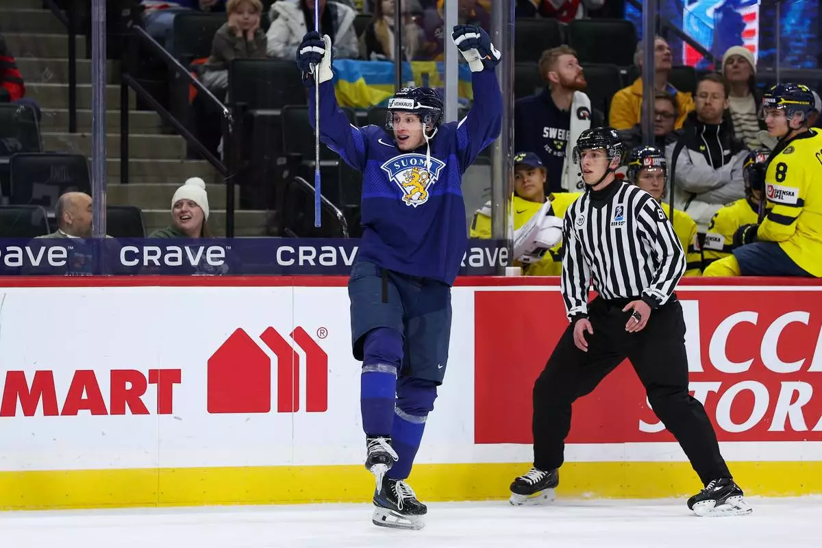 Finland forward Atte Joki (35) celebrates his goal against Sweden during the first period of an IIHF World Junior Hockey Championship semifinals game, Sunday, Jan. 4, 2026, in St. Paul, Minn. (AP Photo/Matt Krohn)
