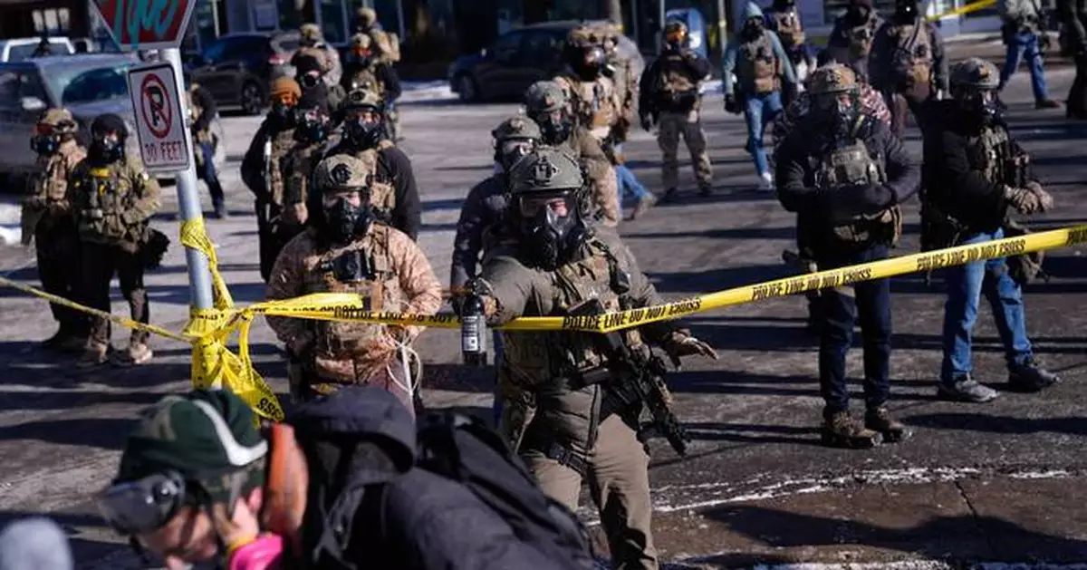 Officers react with crowd after man was killed in Minneapolis amid immigration crackdown, in photos