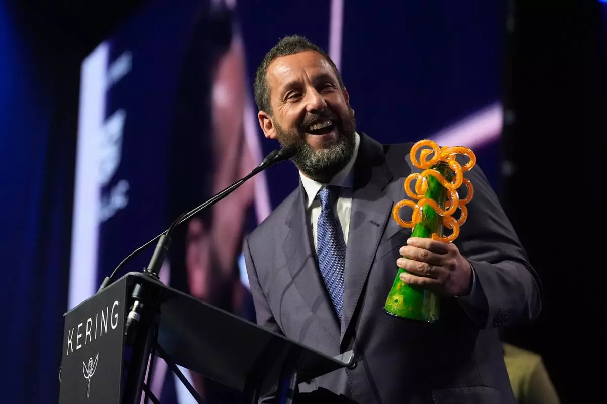 Adam Sandler accepts the chairmans award for "Jay Kelly" during the 37th Palm Springs International Film Festival Film Awards on Saturday, Jan. 3, 2026 at Palm Springs Convention Center in Palm Springs, Calif. (AP Photo/Chris Pizzello)