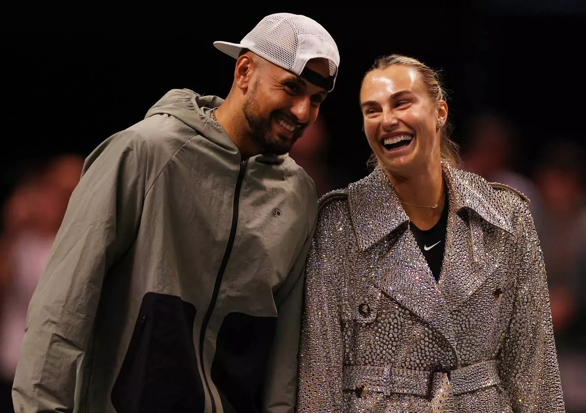 Aryna Sabalenka and Nick Kyrgios laugh ahead of their Battle of the Sexes tennis match in Dubai, United Arab Emirates, Sunday Dec. 28, 2025. (Amr Alfiky/Pool Photo via AP)