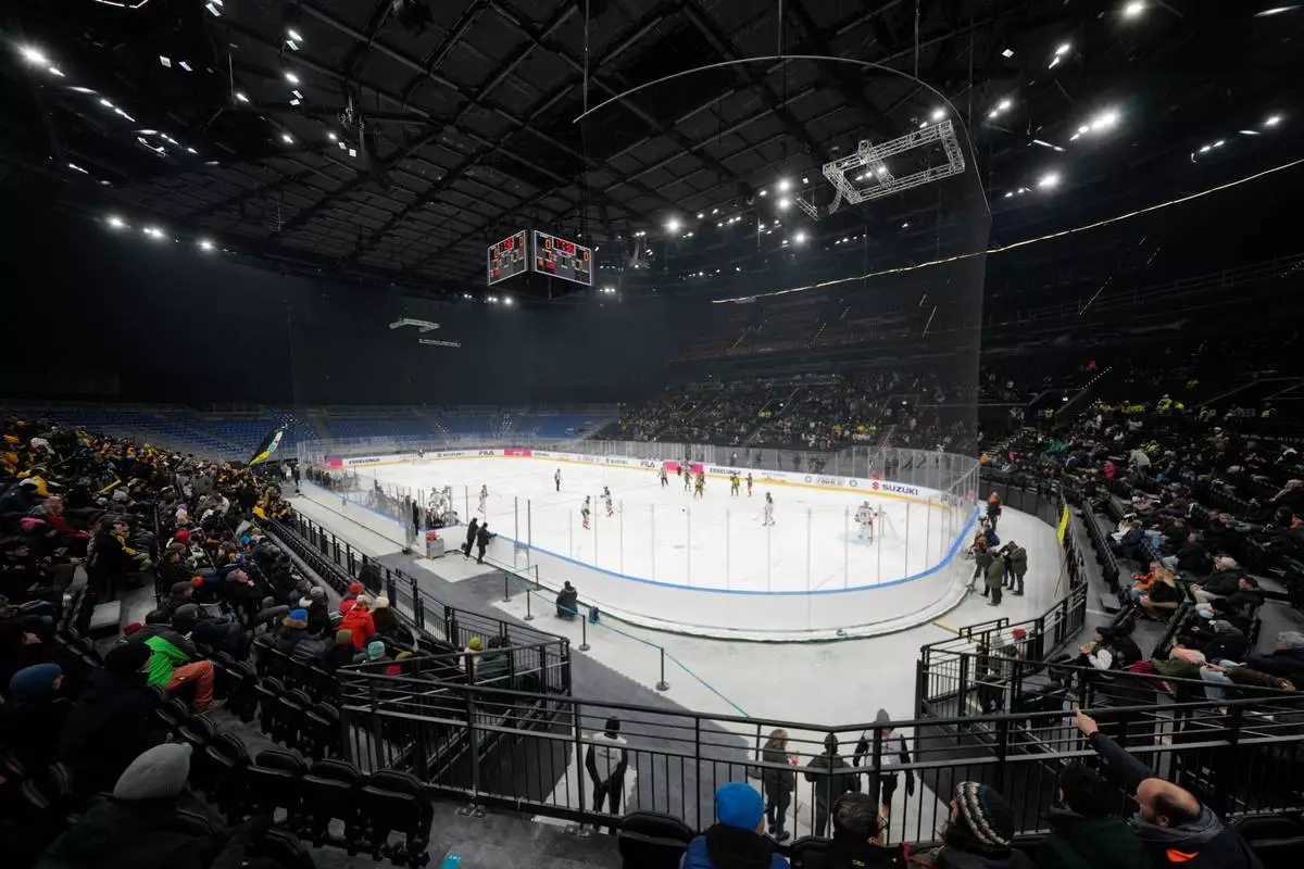 Players battle for the puck during an Hockey Italy's Cup semifinals, SV between Kaltern Caldaro Rothoblaas and HCMV Varese Hockey, at the Olympic test event at the Ice Ockey Arena, in Milan, Italy, Friday, Jan. 9, 2026. (AP Photo/Luca Bruno)