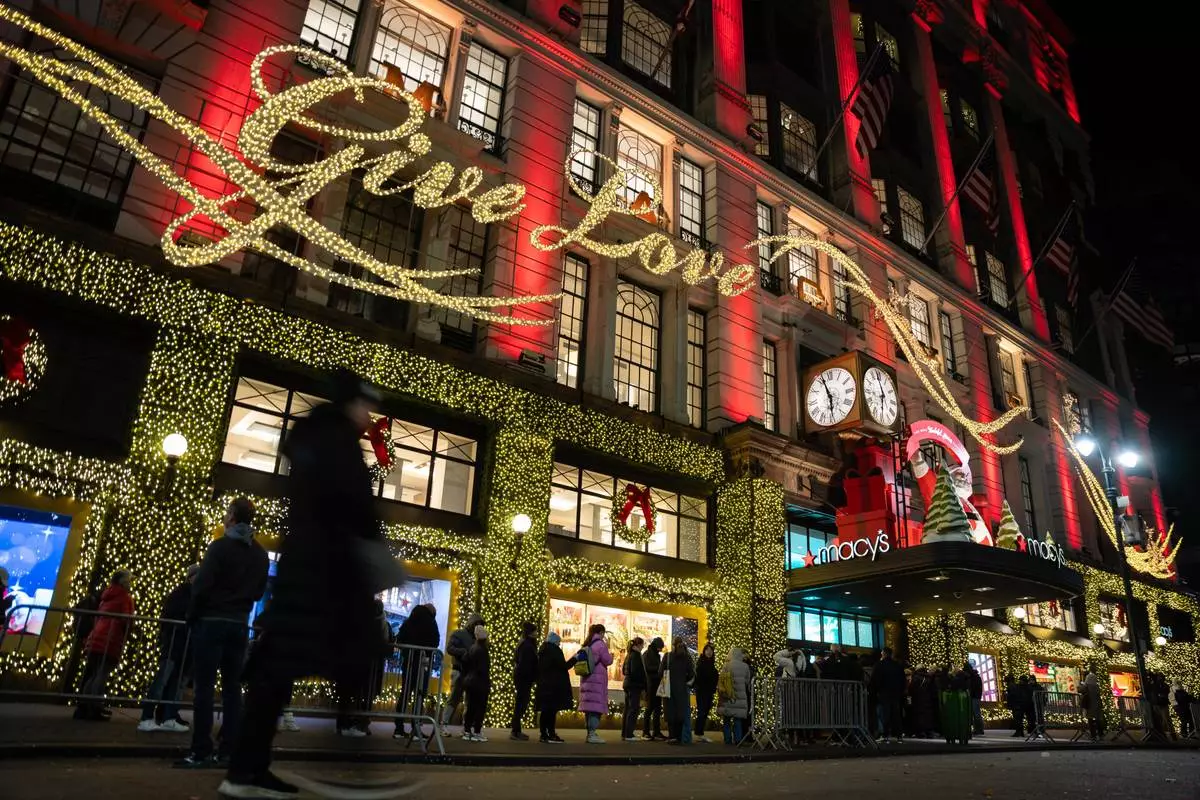 FILE - Shoppers wait in line to enter Macy's flagship store on Nov. 28, 2025 in New York. (AP Photo/Angelina Katsanis, File)