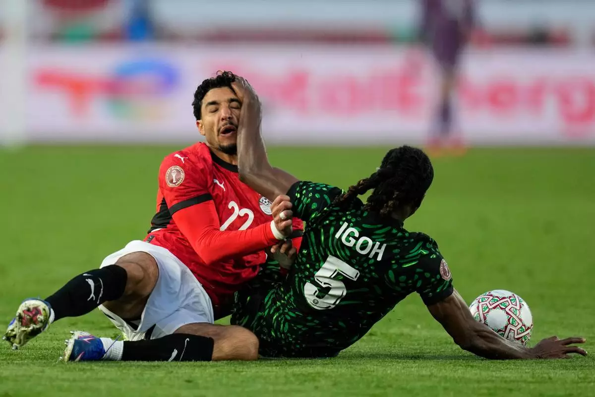 Egypt's Omar Marmoush and Nigeria's Igoh Ogbu compete for the ball during the Africa Cup of Nations third place game between Egypt and Nigeria in Casablanca, Morocco, Saturday, Jan. 17, 2026. (AP Photo/Themba Hadebe)