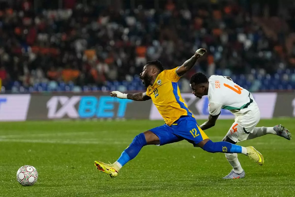 Uganda's Baba Alhassan is challenged by Ivory Coast's Jean-Michael Seri during the Africa Cup of Nations group F soccer match between Gabon and Ivory Coast, in Marrakech, Morocco, Wednesday, Dec. 31, 2025. (AP Photo/Themba Hadebe)
