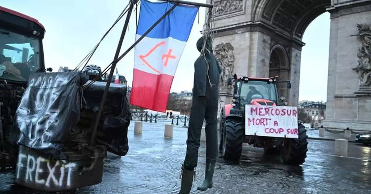 Farmers drive tractors through Paris and block highways in Greece to protest free trade deal