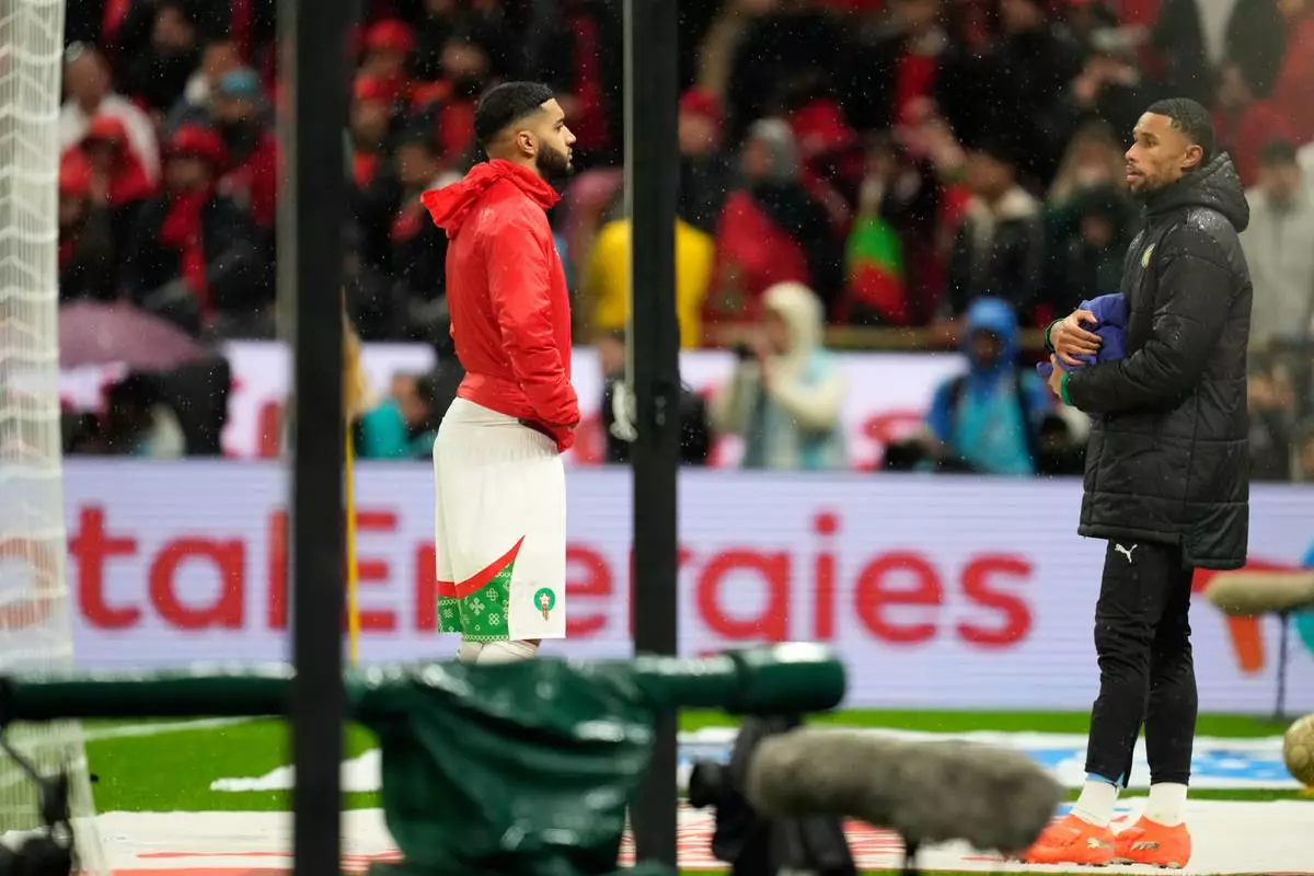 Morocco's Ismael Saibari tries to prevent Senegal's second-choice goalkeeper Yéhvann Diouf from handing a towel to Senegal's goalkeeper Edouard Mendy, during the Africa Cup of Nations final soccer match between Senegal and Morocco, in Rabat, Morocco, Sunday, Jan. 18, 2026. (AP Photo/Mosa'ab Elshamy)