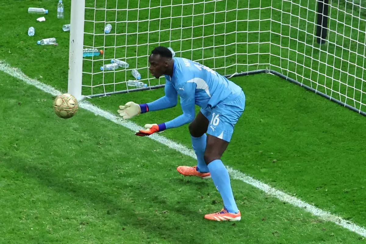 Senegal's goalkeeper Edouard Osoque Mendy saves a panelty from Morocco's Brahim Abdelkader Díaz during the Africa Cup of Nations final soccer match between Senegal and Morocco in Rabat, Morocco, Sunday, Jan. 18, 2026. (AP Photo/Youssef Loulidi)