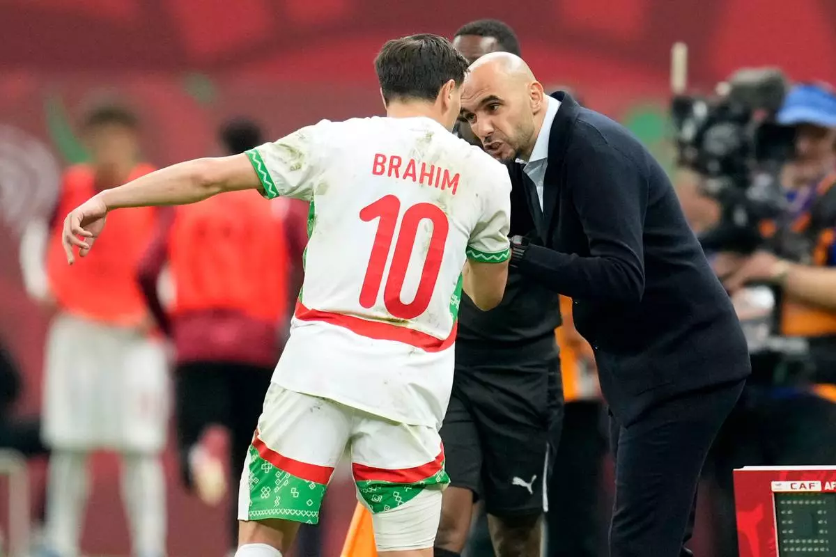 Morocco's head coach Walid Regragui talks to Morocco's Brahim Abdelkader Díaz during the Africa Cup of Nations quarterfinal soccer match between Cameroon and Morocco, in Rabat, Morocco, Friday, Jan. 9, 2026. (AP Photo/Mosa'ab Elshamy)