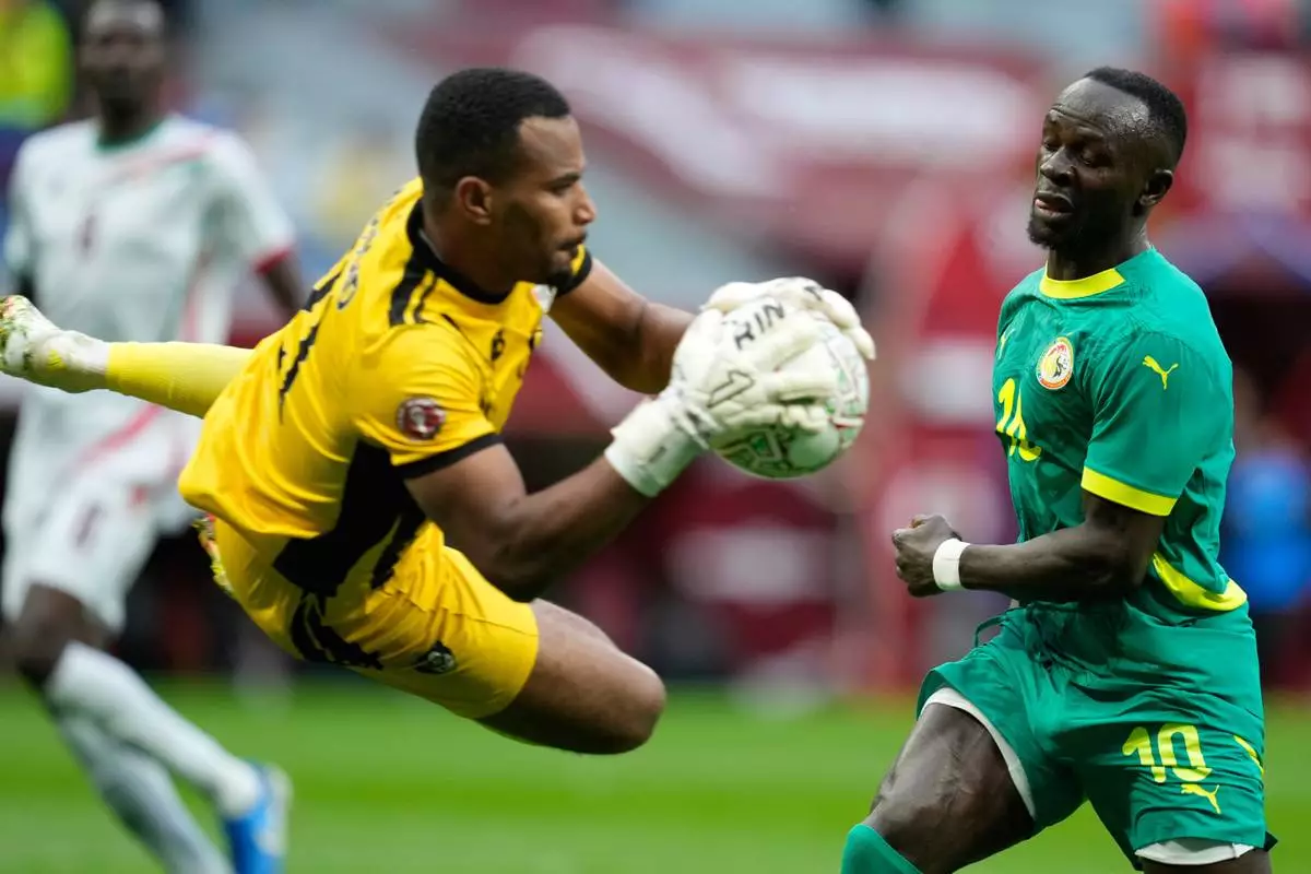Sudan's goalkeeper Monged Elneel Abuzaid saves in front of Senegal's Sadio Mane during the Africa Cup of Nations best of 16 soccer match between Senegal and Sudan in Tangier, Morocco, Saturday, Jan. 3, 2026. (AP Photo/Mosa'ab Elshamy)