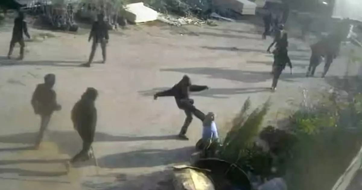 Video shows armed men beating a Palestinian in the Israeli-occupied West Bank