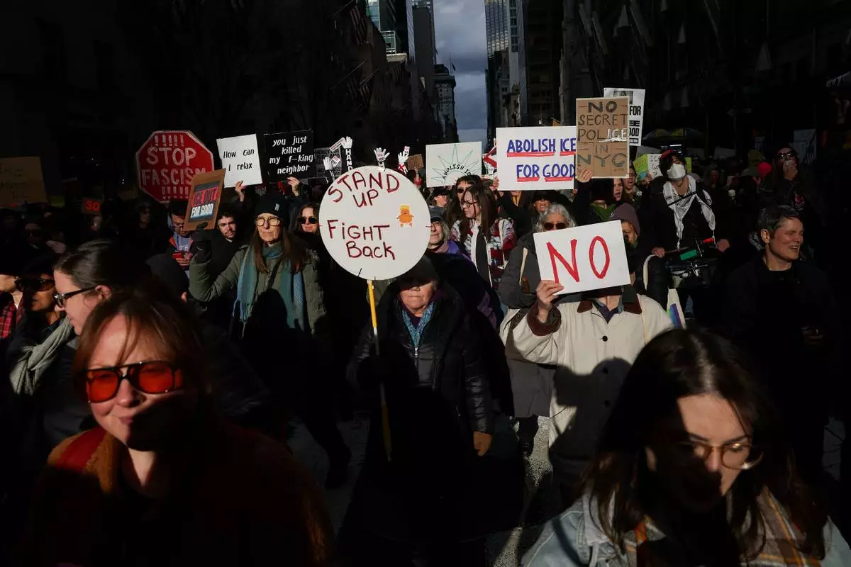Demonstrators march down Fifth Avenue during a protest against war in Venezuela and Immigration and Customs Enforcement, Sunday, Jan. 11, 2026, in New York. (AP Photo/Heather Khalifa)