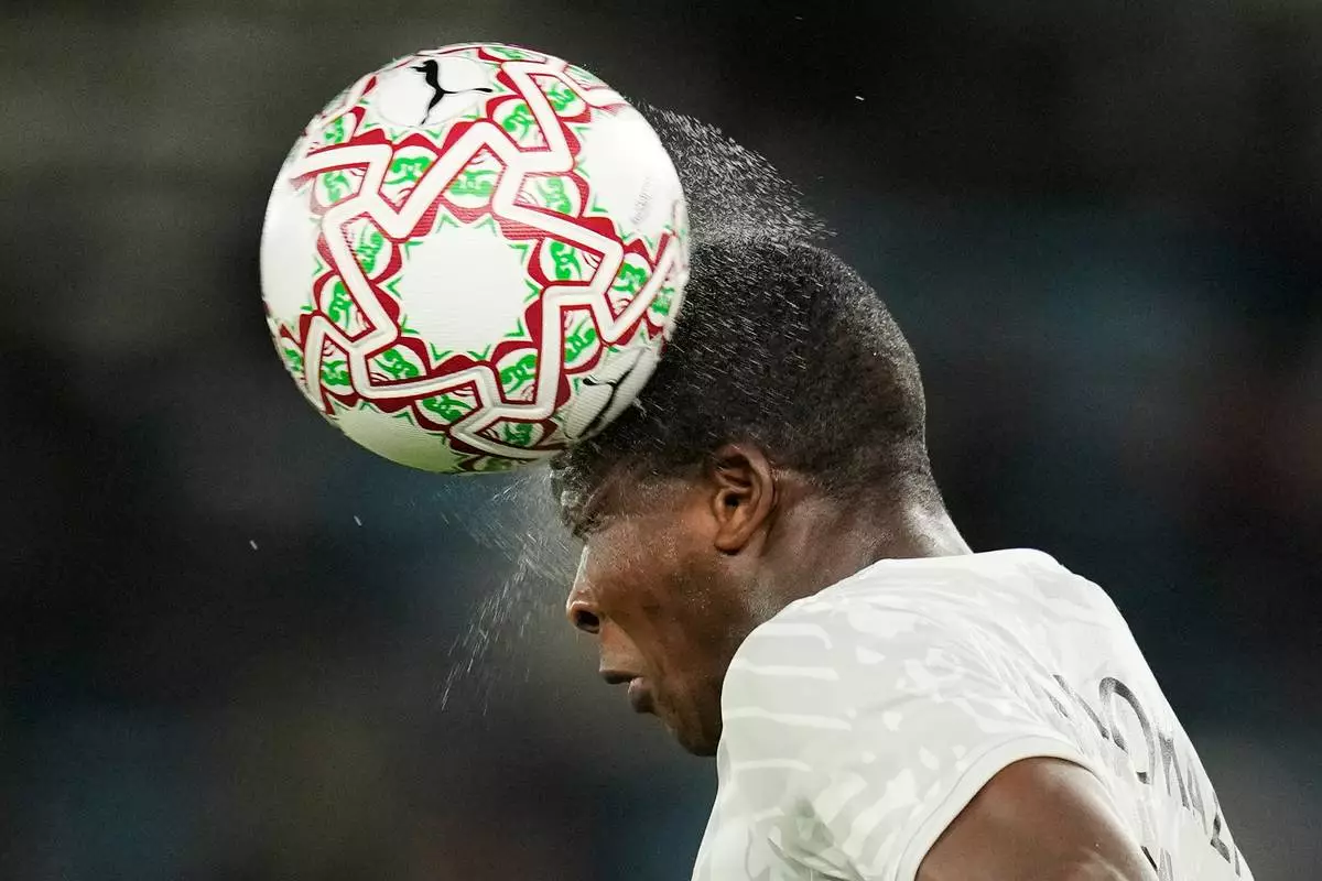 South Africa's Mbekezeli Mbokazi heads the wet ball during the Africa Cup of Nations round of 16 soccer match between South Africa and Cameroon in Rabat, Morocco, Sunday, Jan. 4, 2026. (AP Photo/Themba Hadebe)