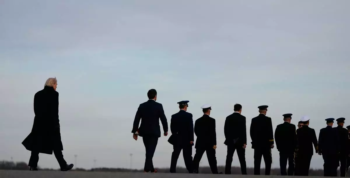 FILE - President Donald Trump arrives with his Defense Secretary Pete Hegseth and Chairman of the Joint Chiefs Air Force Gen. Dan Caine to Dover Air Force Base in Delaware, Dec. 17, 2025, for the casualty return of Iowa National Guard soldiers Sgt. William Nathaniel Howard, 29, of Marshalltown, Iowa, and Sgt. Edgar Brian Torres-Tovar, 25, of Des Moines, Iowa, and civilian interpreter Ayad Mansoor Sakat, who were killed in an attack in Syria. (AP Photo/Julia Demaree Nikhinson, File)