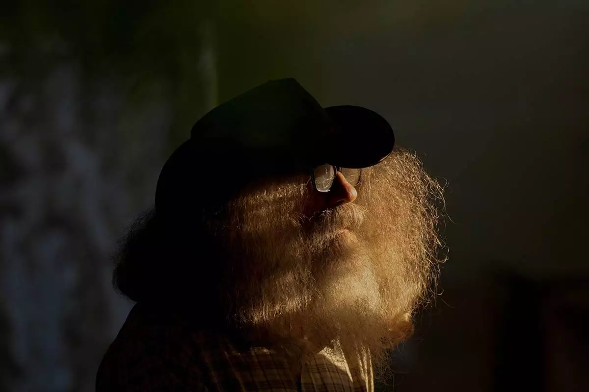 FILE - Henry County local correspondent Joe Durbin pauses in the late day sun as he interviews participants during the Beef Bash 2025 tasting event at the Berry Center, Oct. 11, 2025, in New Castle, Kentucky. (AP Photo/Carolyn Kaster, File)