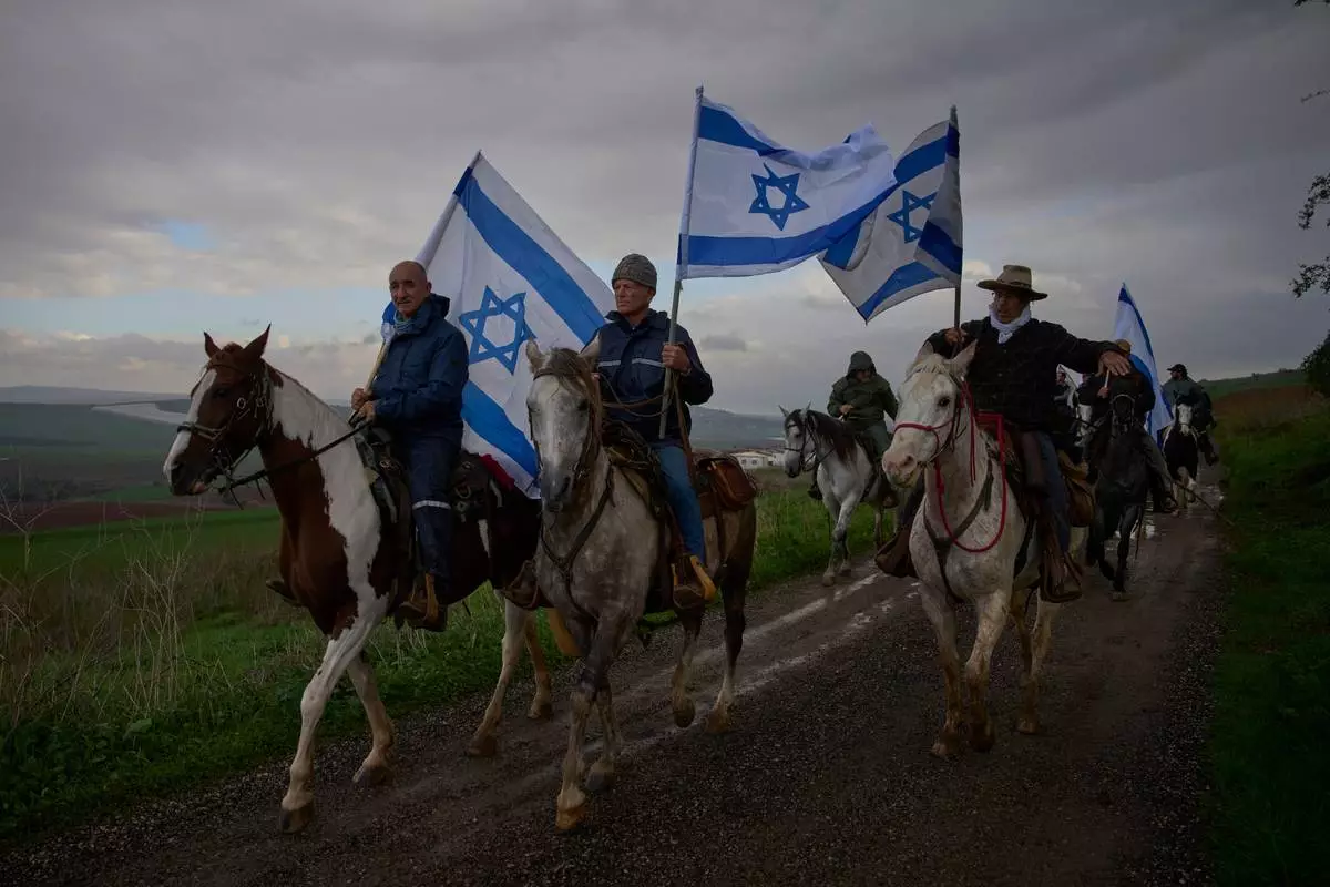 FILE - Israelis ride on horseback for the funeral procession of Aviv Maor, an 18-year-old Israeli who was killed by a Palestinian attacker the previous week, at Kibbutz Ein Harod cemetery in northern Israel, Dec. 29, 2025. (AP Photo/Ohad Zwigenberg, File)