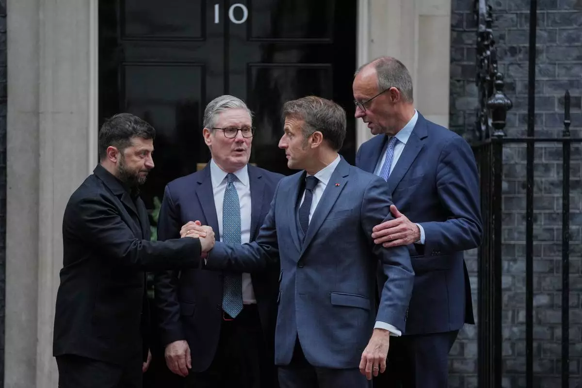FILE - Ukraine's President Volodymyr Zelenskyy, from left, Britain's Prime Minister Keir Starmer, France's President Emmanuel Macron, and Germany's Chancellor Friedrich Merz pose for photos after their meeting at 10 Downing Street, London, Dec. 8, 2025. (AP Photo/Kin Cheung, File)