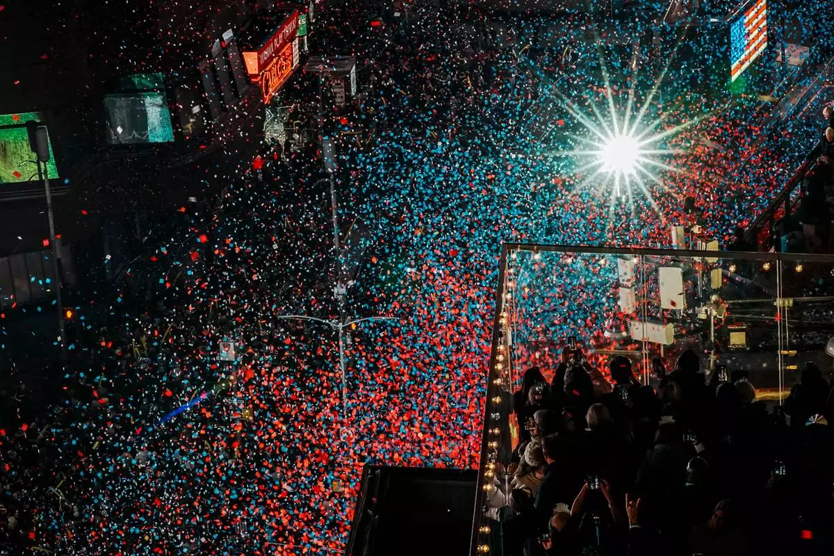 FILE - Confetti falls over attendees in Times Square during New Year's Eve celebration, Thursday, Jan. 1, 2026, in New York. (AP Photo/Eduardo Munoz Alvarez, File)