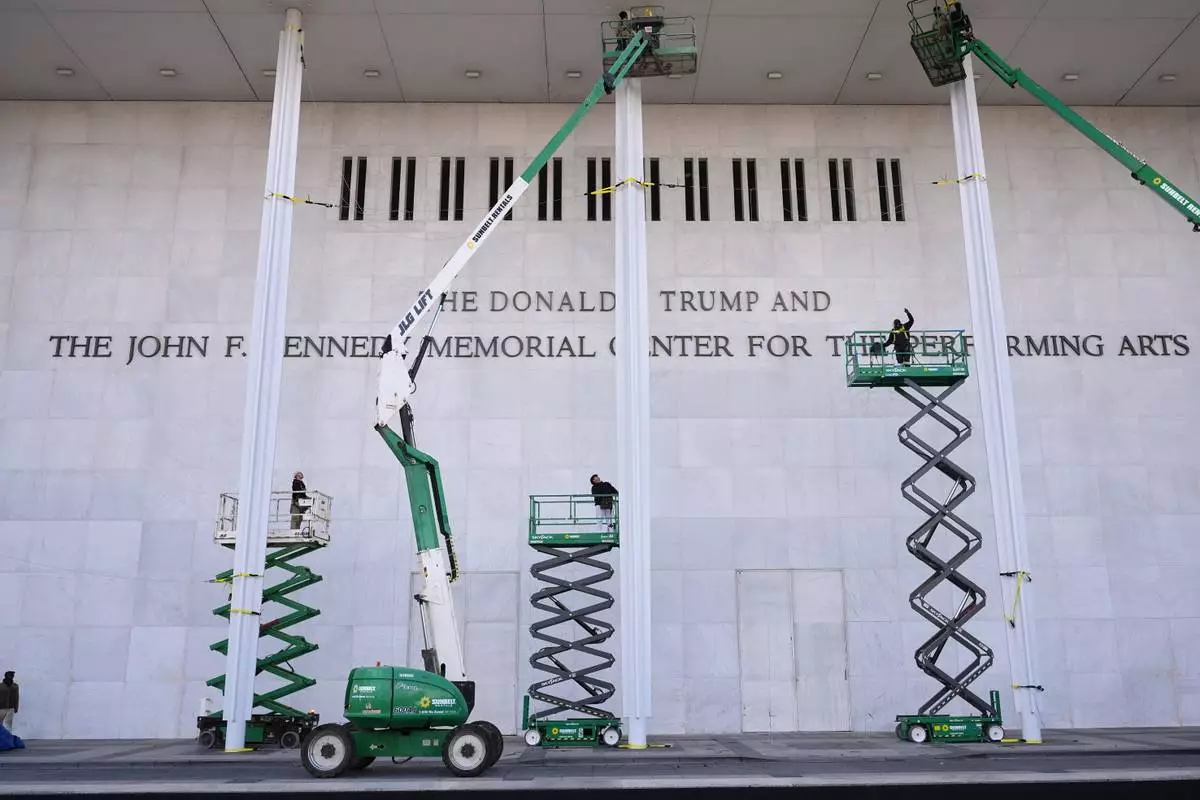 FILE - New signage, The Donald J. Trump and The John F. Kennedy Memorial Center For The Performing Arts, is unveiled on the Kennedy Center in Washington, Dec. 19, 2025. (AP Photo/Jacquelyn Martin), File)