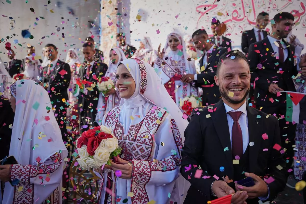FILE - Palestinian brides and grooms get married at a mass wedding ceremony in Hamad City in Khan Younis, Gaza Strip, Dec. 2, 2025. (AP Photo/Abdel Kareem Hana, File)