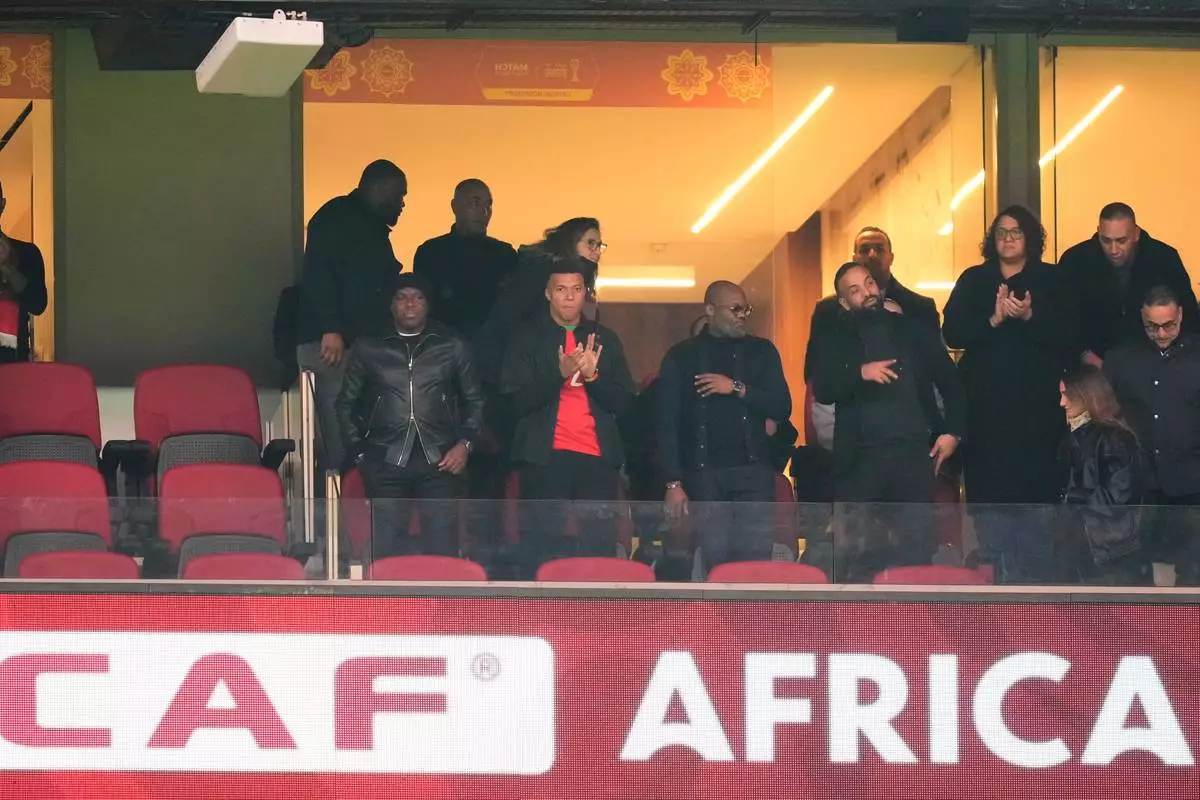 French forward Kylian Mbappé, centre, attends the African Cup of Nations Group A soccer match between Morocco and Mali in Rabat, Friday, Morocco 26, 2025. (AP Photo/Mosa'ab Elshamy)