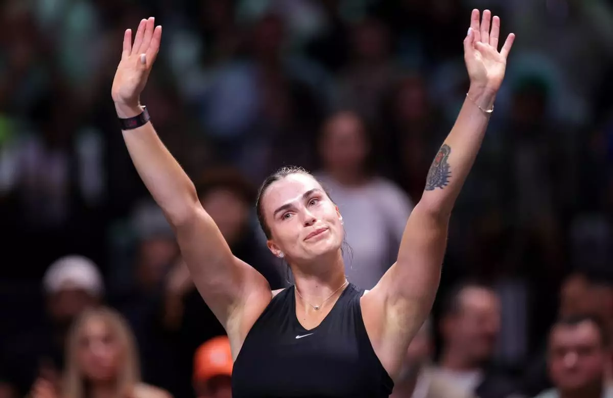 Aryna Sabalenka acknowledges the crowd after losing against Nick Kyrgios in their Battle of the Sexes match, in Dubai, United Arab Emirates, Sunday Dec. 28, 2025. (Christopher Pike/Pool Photo via AP)