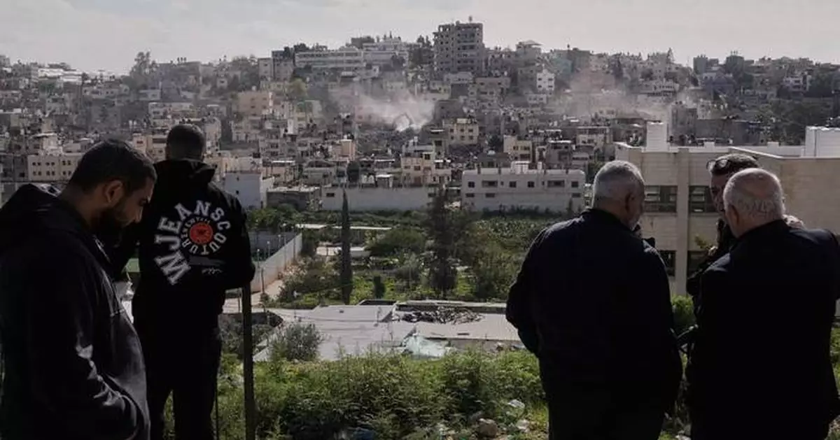 Palestinians watch as Israeli bulldozers claw down their West Bank homes