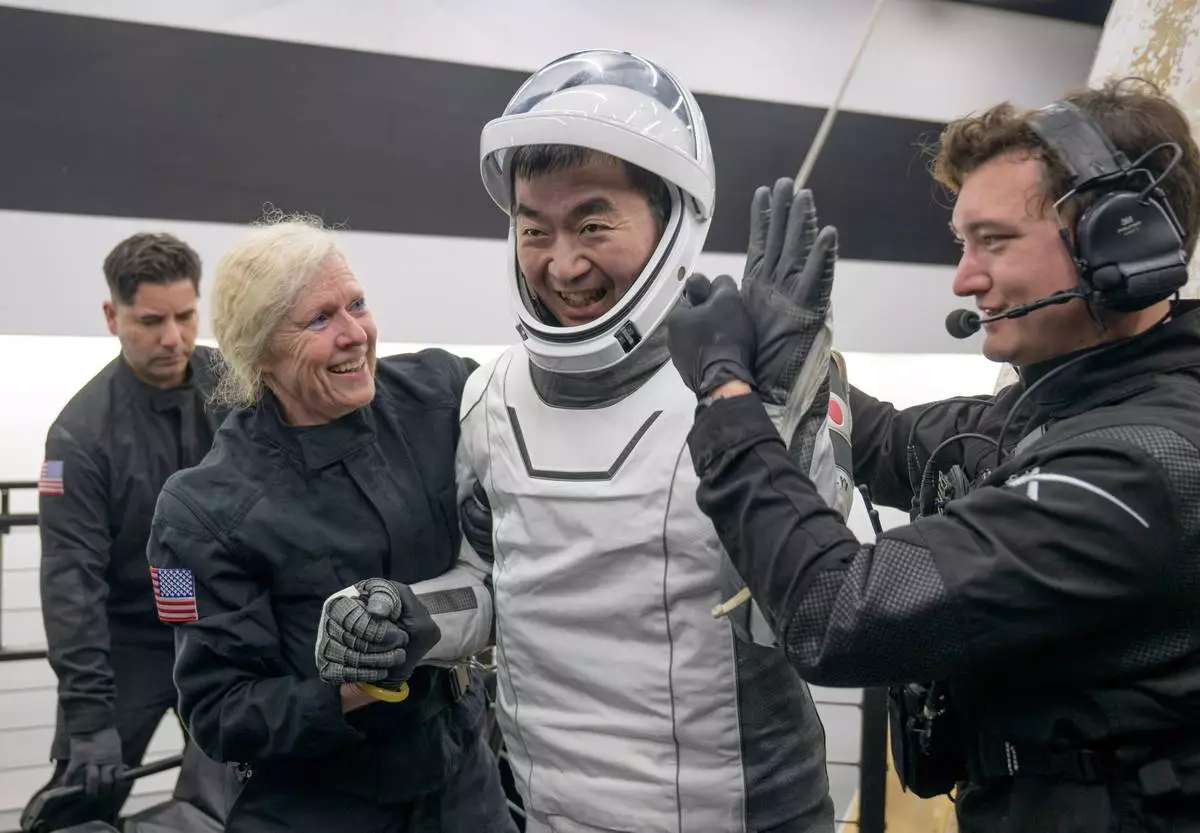 JAXA (Japan Aerospace Exploration Agency) astronaut Kimiya Yui is helped out of the SpaceX Crew-11 capsule after they re-entered the earth in a middle-of-the-night splashdown near San Diego, Calif., Thursday, Jan. 15, 2026. (NASA via AP)