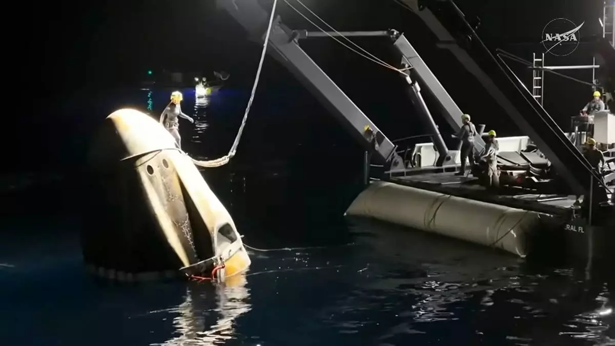 This screengrab from video provided by NASA shows the NASA's SpaceX Crew-11 capsule being taken into the recovery vessel after crew members re entered the earth in a middle-of-the-night splashdown near San Diego, Calif., Thursday, Jan. 15, 2026. (NASA via AP)