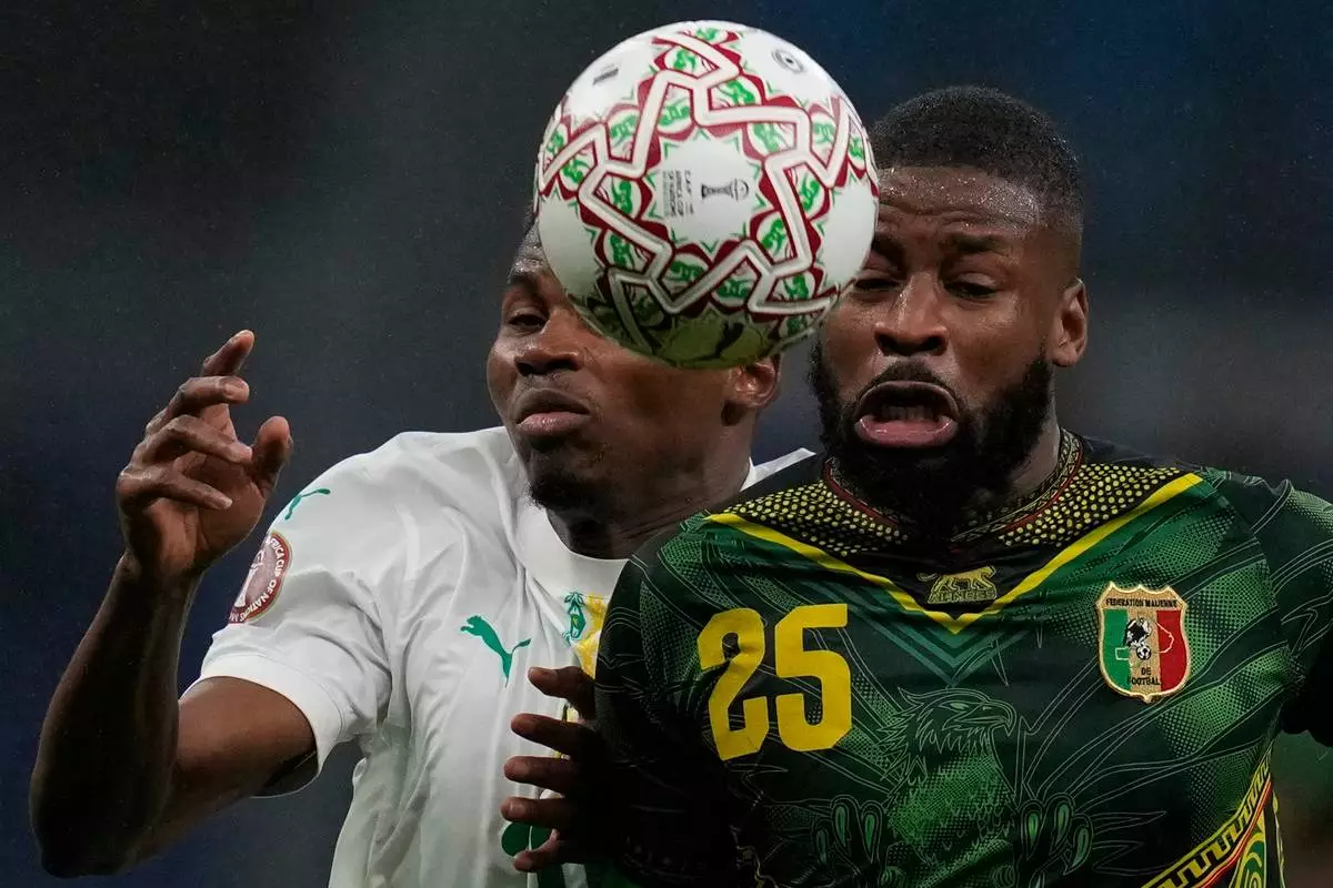Senegal's Mouhamadou Diallo, left, and Mali's Ousmane Camara fight for the ball during the Africa Cup of Nations quarterfinal soccer match between Senegal and Mali in Tangier, Morocco, Friday, Jan. 9, 2026. (AP Photo/Themba Hadebe)